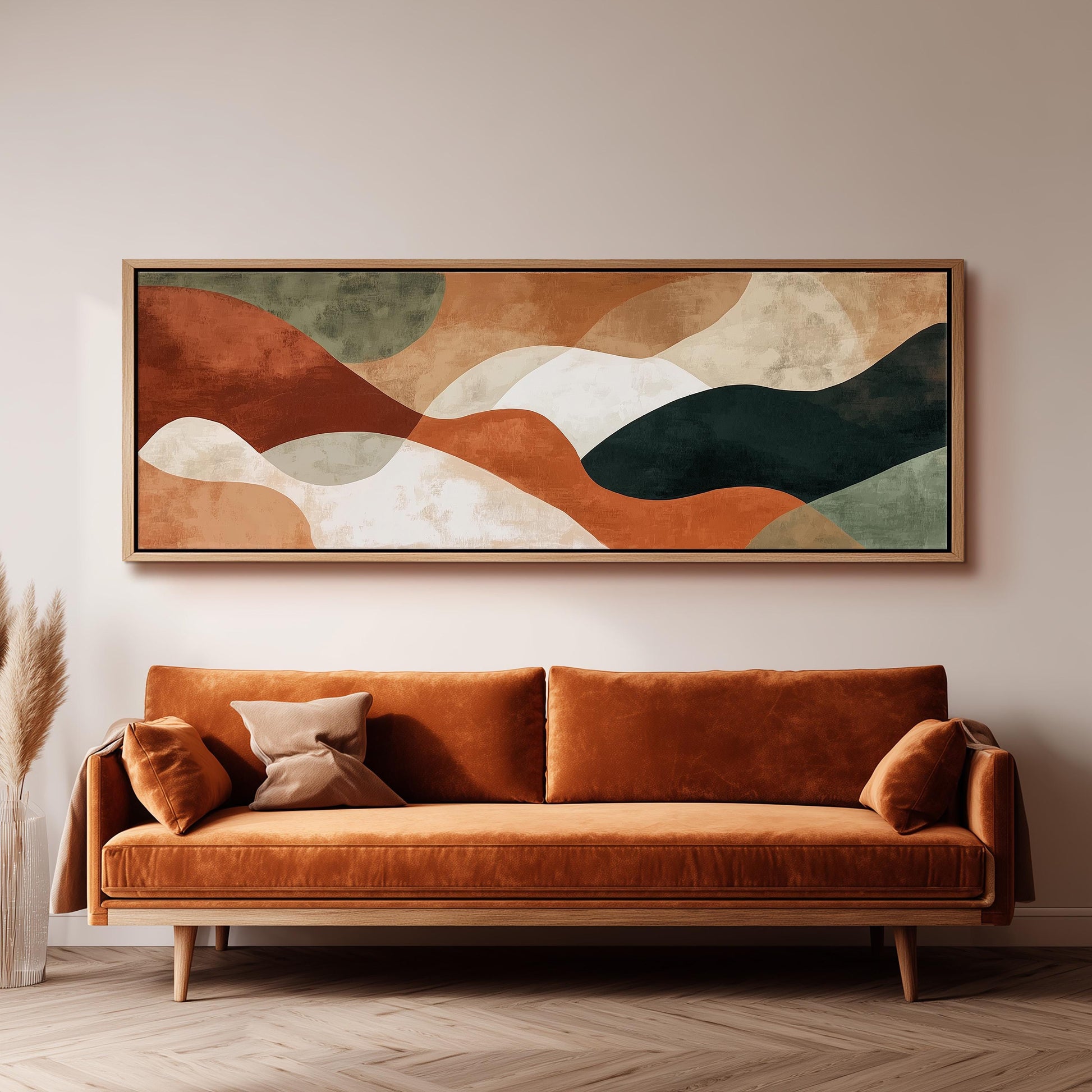 a large abstract painting hanging on a wall above a brown sofa with two pillows.