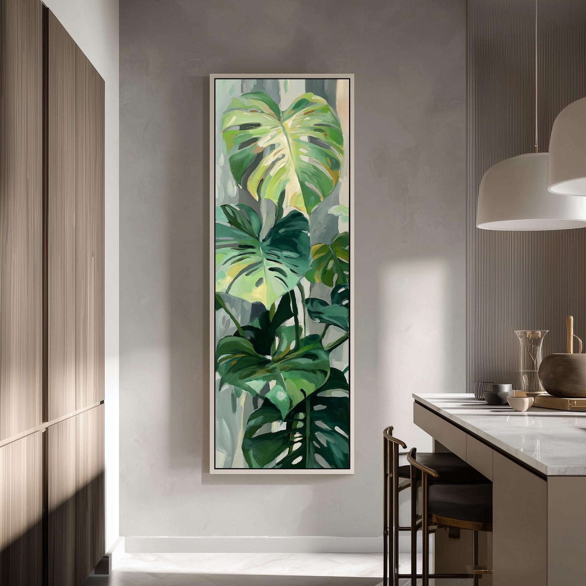 a large painting of green leaves hanging on a wall in a modern kitchen.