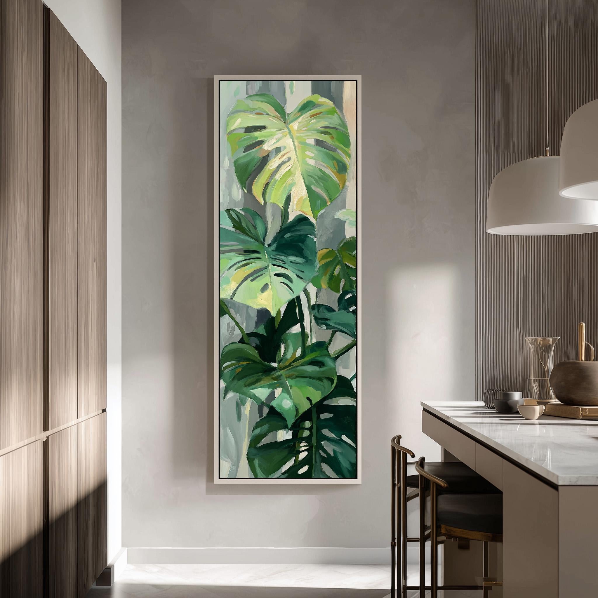a large painting of green leaves hanging on a wall in a modern kitchen.