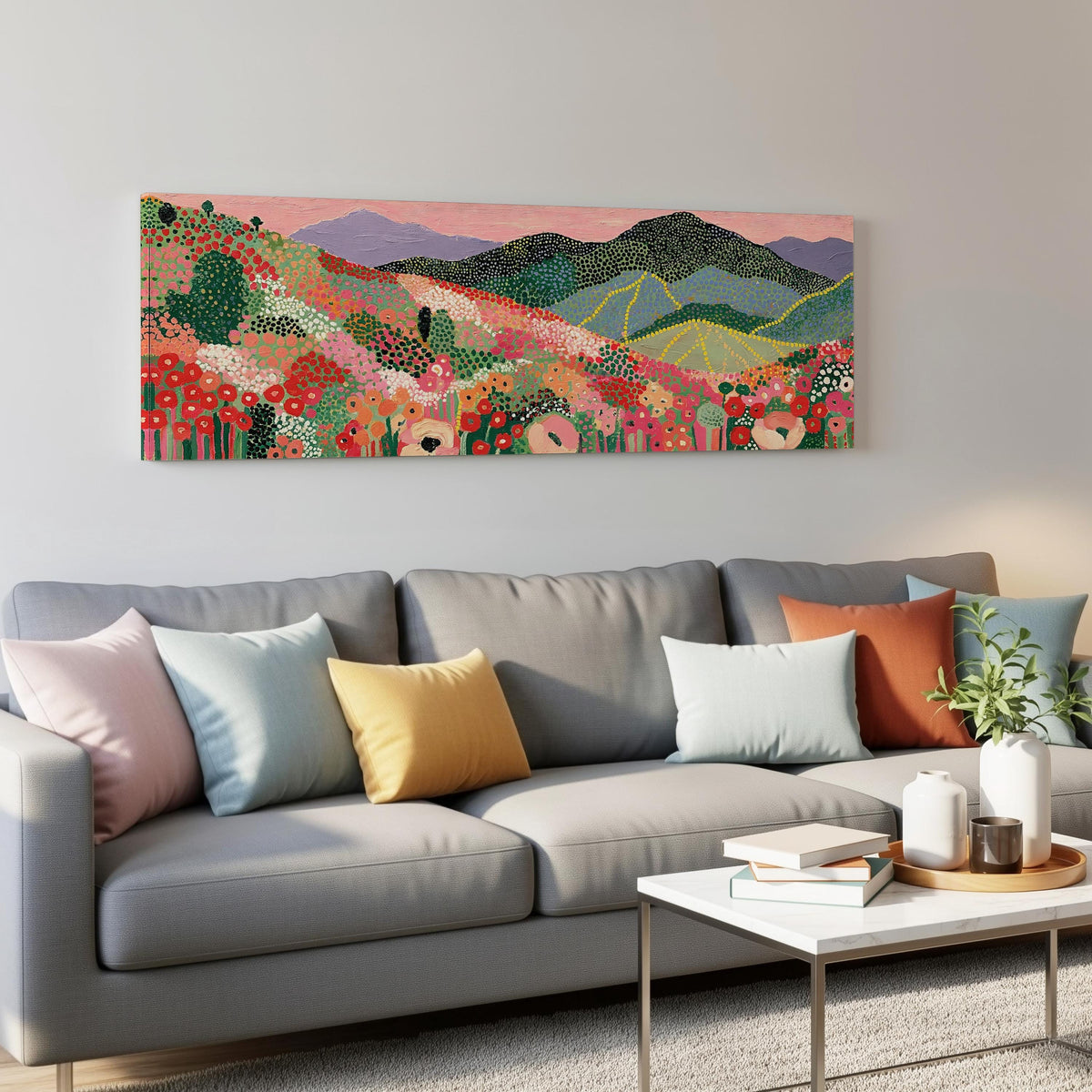 Dotted poppy mountains under a pink sky panoramic canvas print above a grey sofa in a living room
