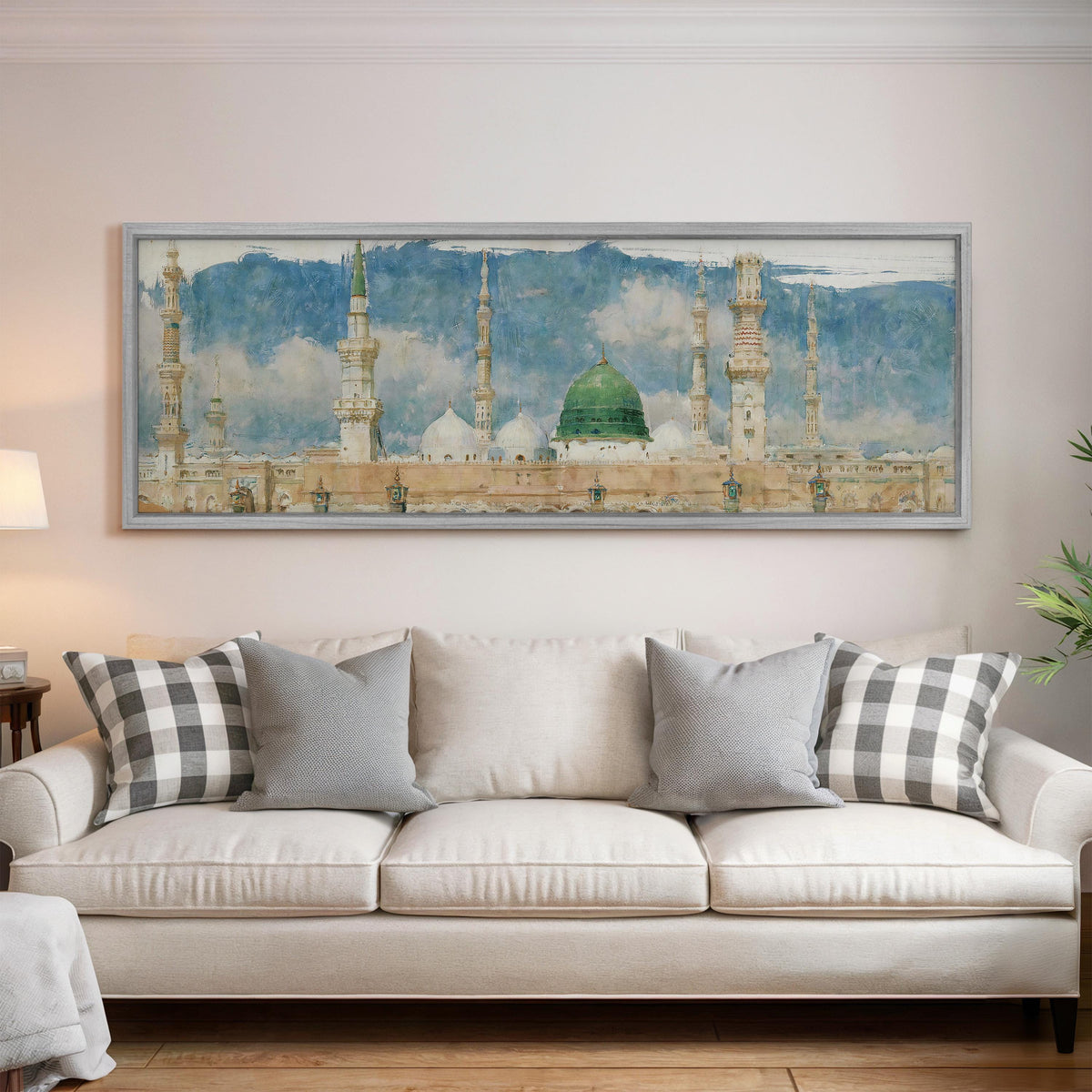 The green dome of the Prophet's Mosque in Medina panoramic canvas print above a white sofa in a bright living room