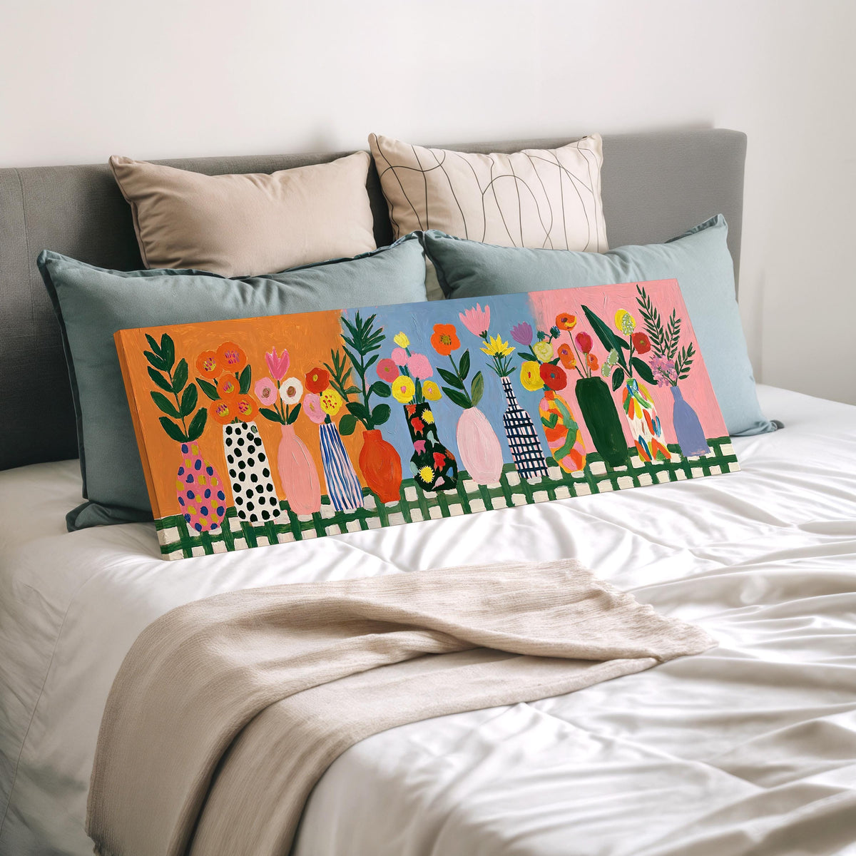 Folk art flower vases on orange and blue wide panoramic canvas print laid on a bed to show its size