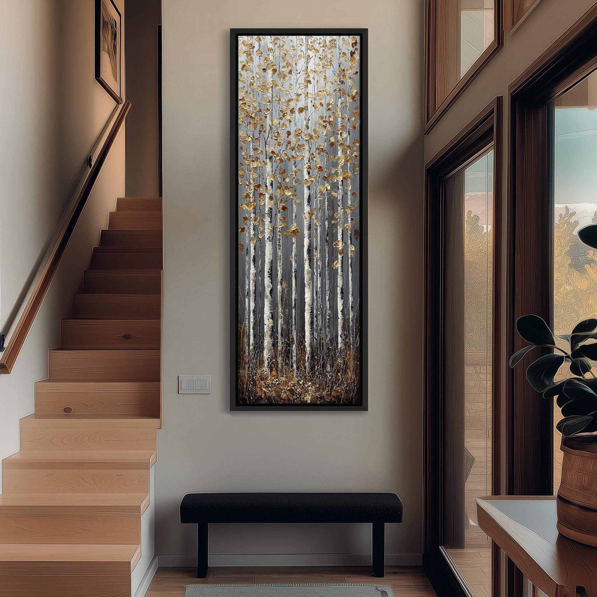 a hallway with a large painting of birch trees hanging on the wall, a wooden staircase, a black bench, and a plant in a pot.