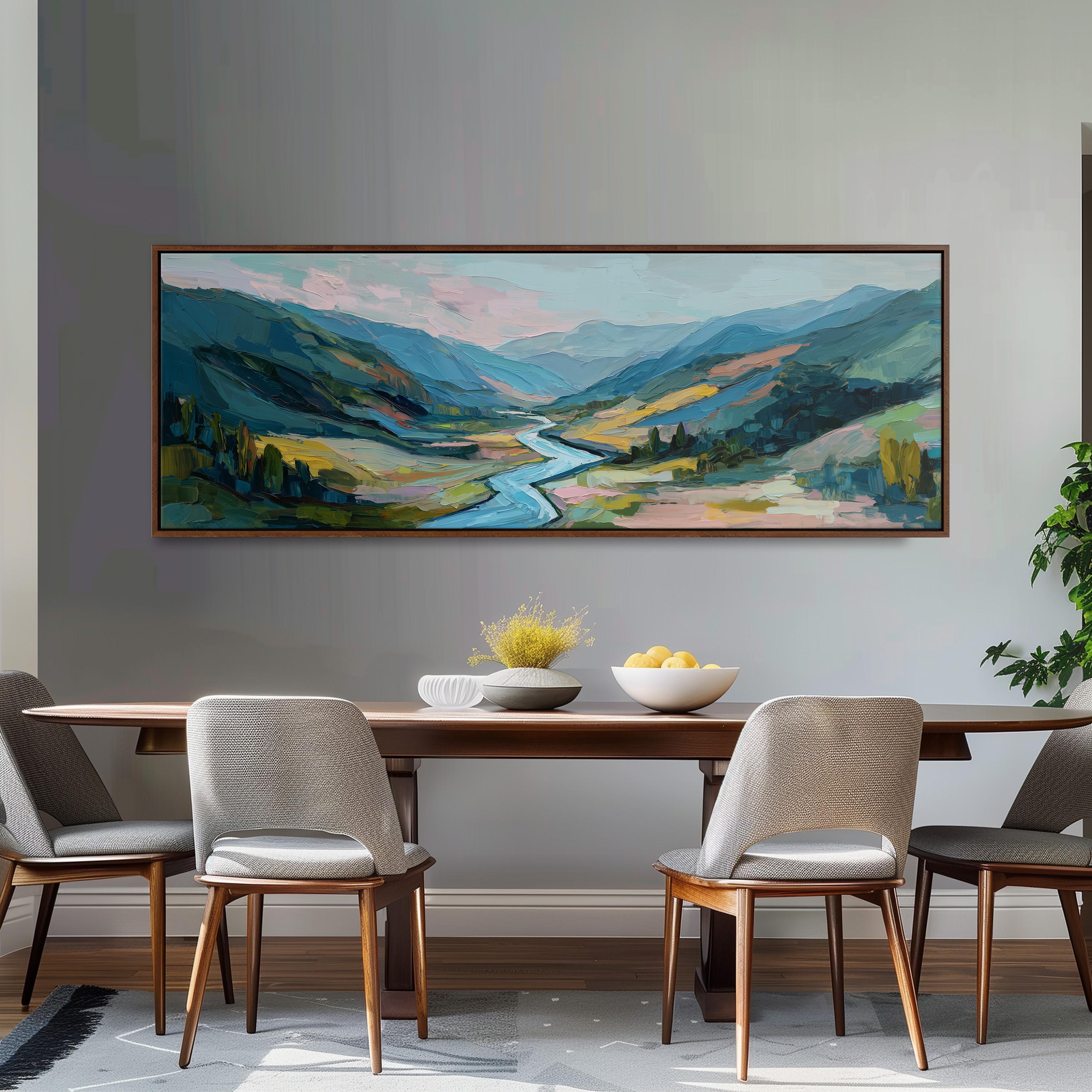 a large painting of a scenic landscape hanging on a wall above a wooden dining table with four chairs. The painting depicts a winding river surrounded by mountains and lush greenery, creating a serene and picturesque setting.