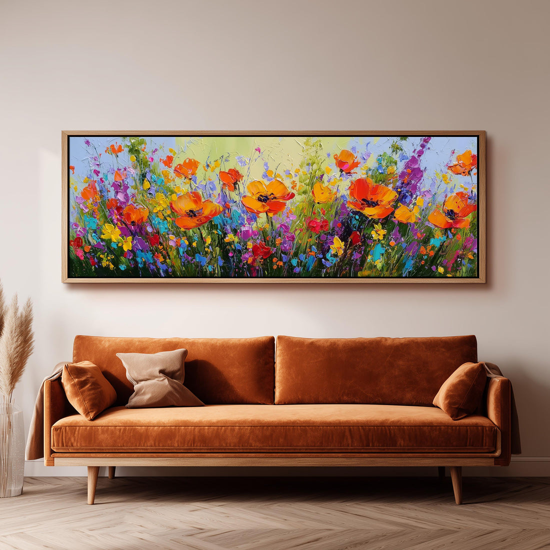 a large, vibrant painting of a field of flowers hanging on a wall above a brown sofa.