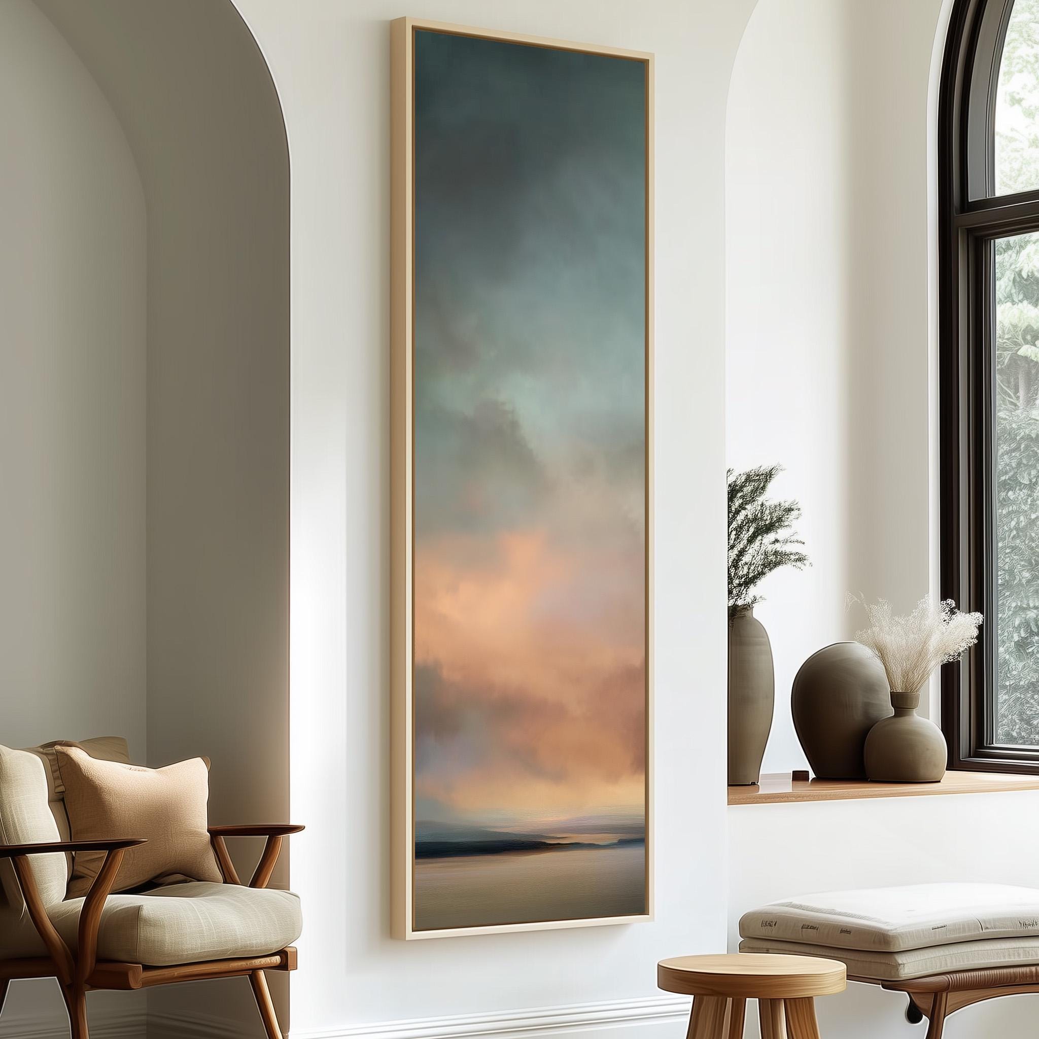 a large painting hanging on a white wall, with a wooden chair and a small table in the foreground.