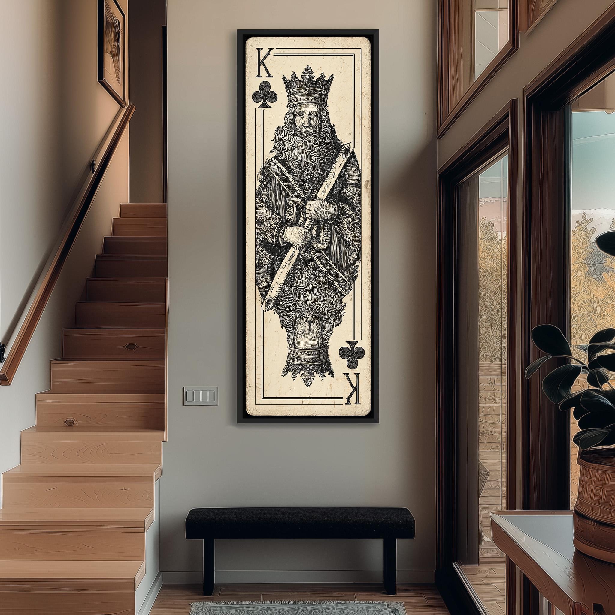 a large framed artwork depicting a king, with the king wearing a crown and holding a club in his hand. The artwork is mounted on a wall in a hallway, with a staircase visible in the background.