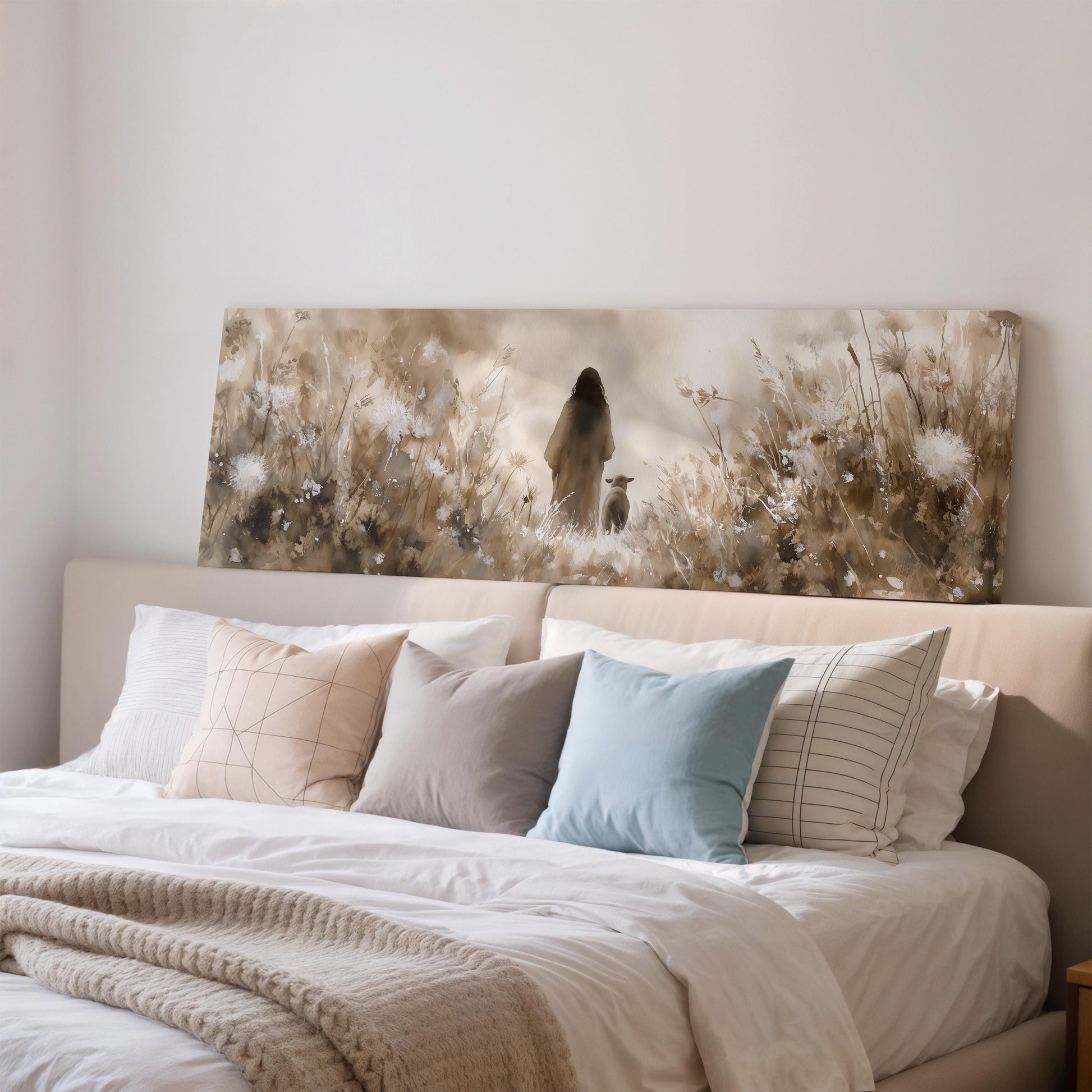 a large bed with a white comforter and various pillows, including a blue pillow and a striped pillow. Above the bed, there is a large painting depicting a woman walking through a field of flowers.