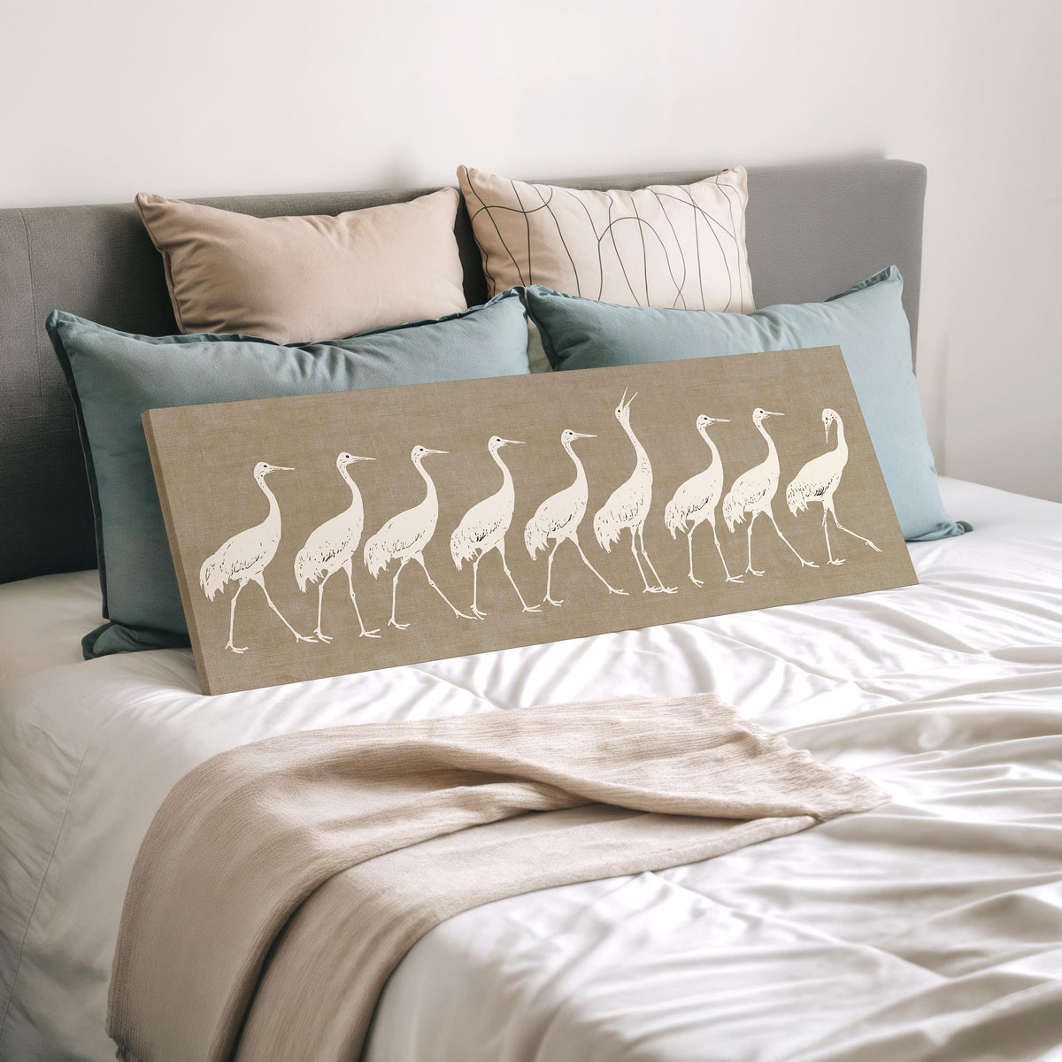 Procession of white cranes on linen wide panoramic canvas print laid on a bed to show its size