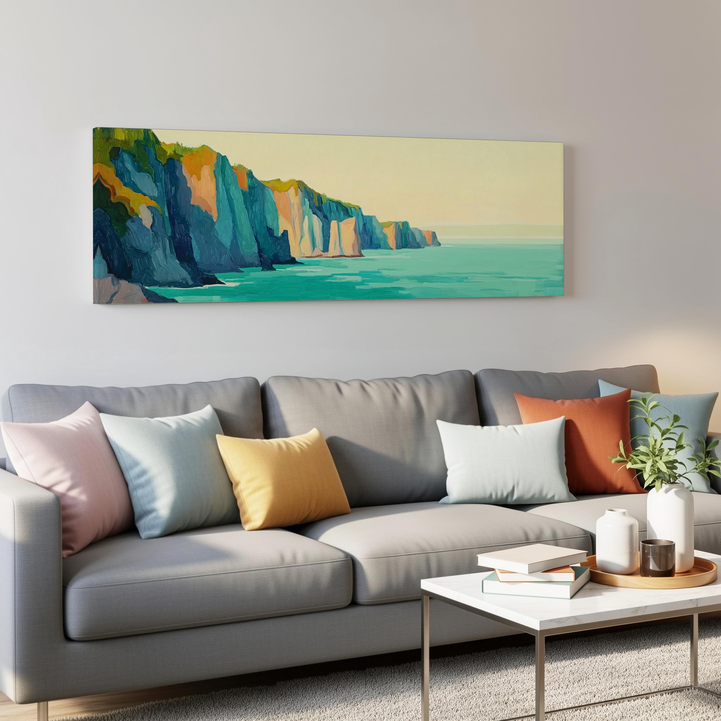 a living room with a gray sofa adorned with colorful throw pillows, a white coffee table, and a painting of a cliff overlooking the ocean hanging on the wall above the sofa.