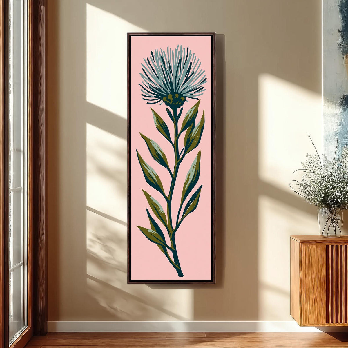 Blue thistle flower on blush pink tall narrow canvas print beside a staircase in an entryway