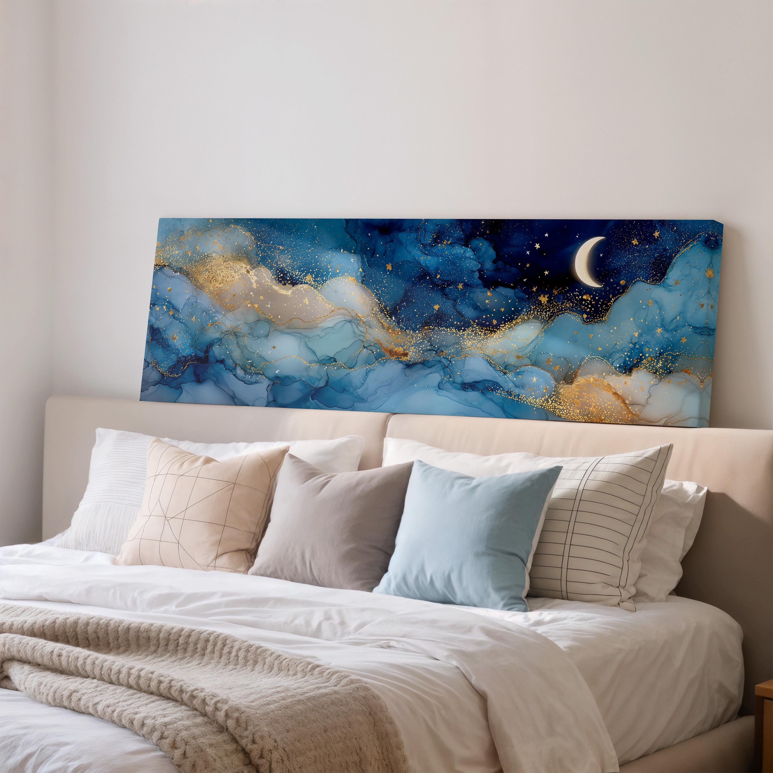 a large bedroom with a bed adorned with white pillows and a blue and gold abstract painting hanging above it.