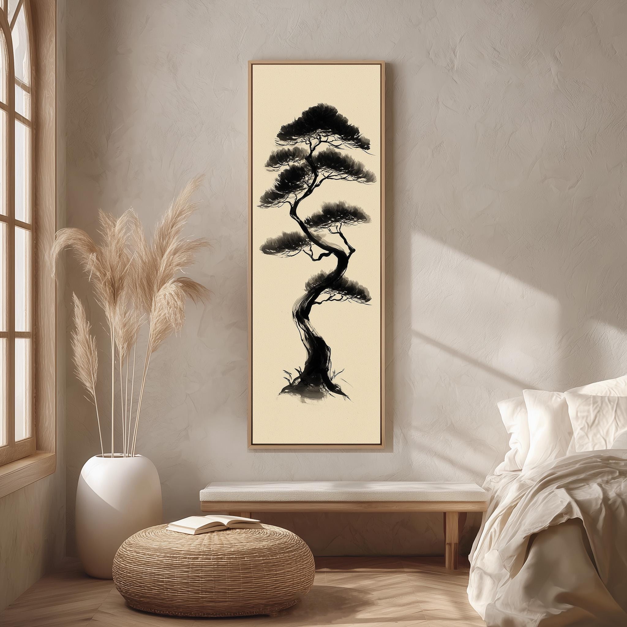 a serene and minimalist bedroom setting with a large framed picture of a tree hanging on the wall. The room has a bed, a bench, and a potted plant, creating a calm and peaceful atmosphere.