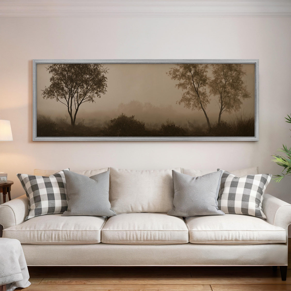 Two trees in sepia fog panoramic canvas print above a white sofa in a bright living room