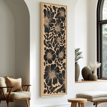 a modern living room with a large floral wall art piece hanging on the wall. The room is furnished with a wooden chair, a small table, and a window with a view of trees outside.