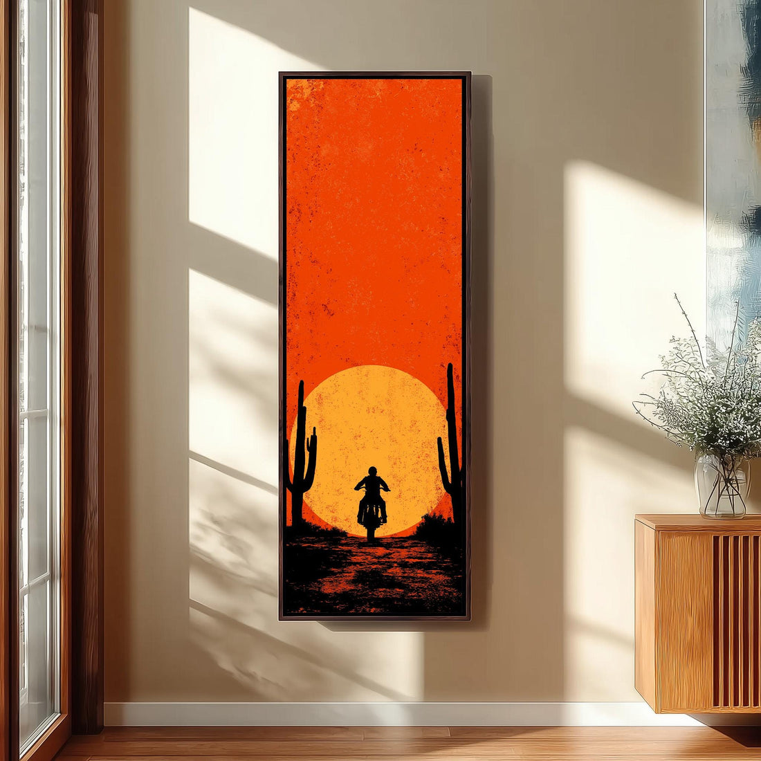 a large, vibrant painting of a desert scene with a cactus and a motorcycle, hanging on the wall of a hallway.