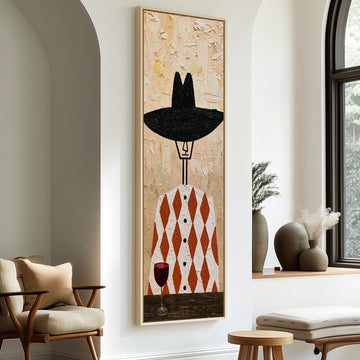 Folk figure in a black hat with red wine long vertical canvas print in a sunlit living space