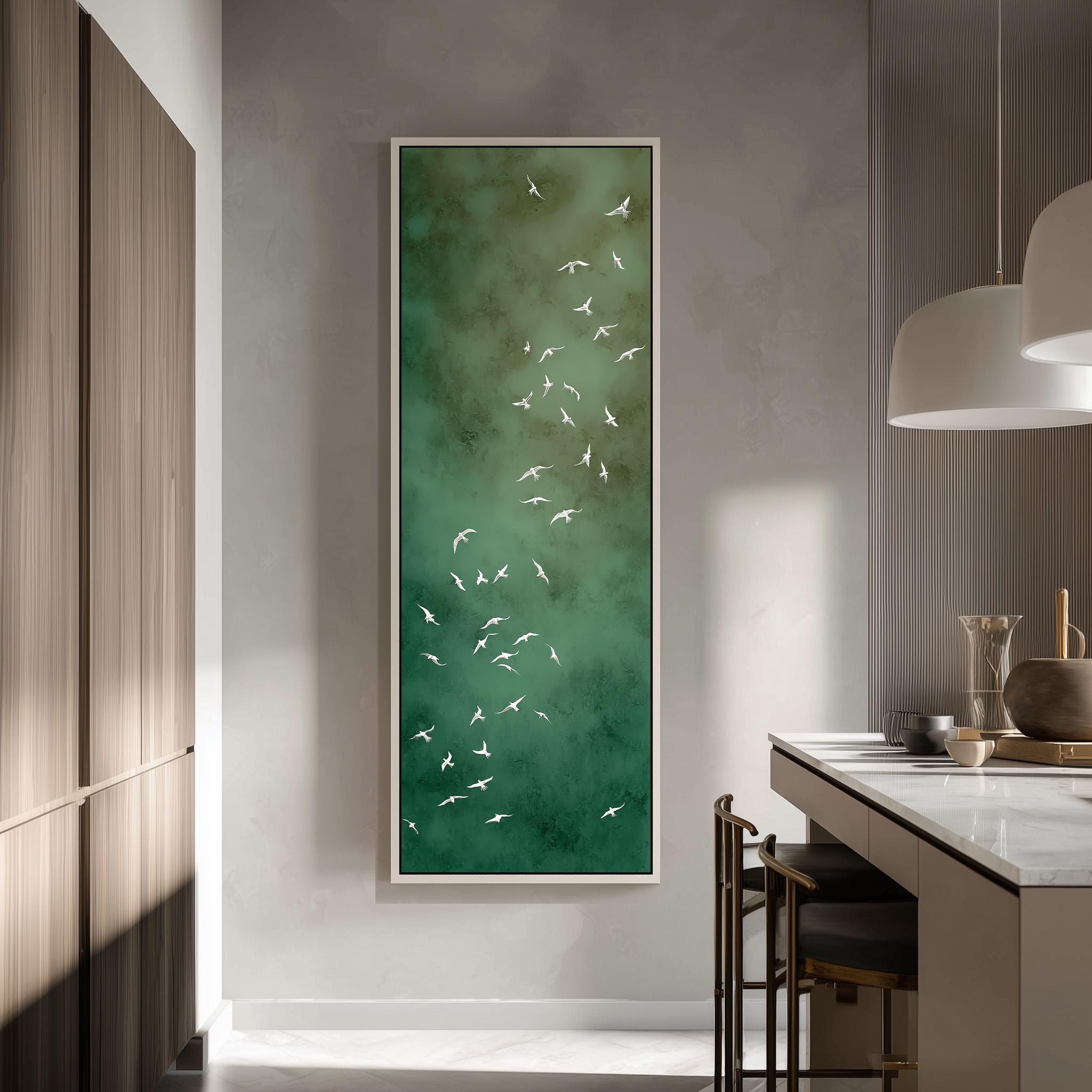 a modern kitchen with a large green abstract painting hanging on the wall, depicting a flock of white birds.