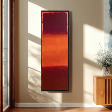Color field bands in maroon, orange and red long vertical canvas print in a sunlit living space