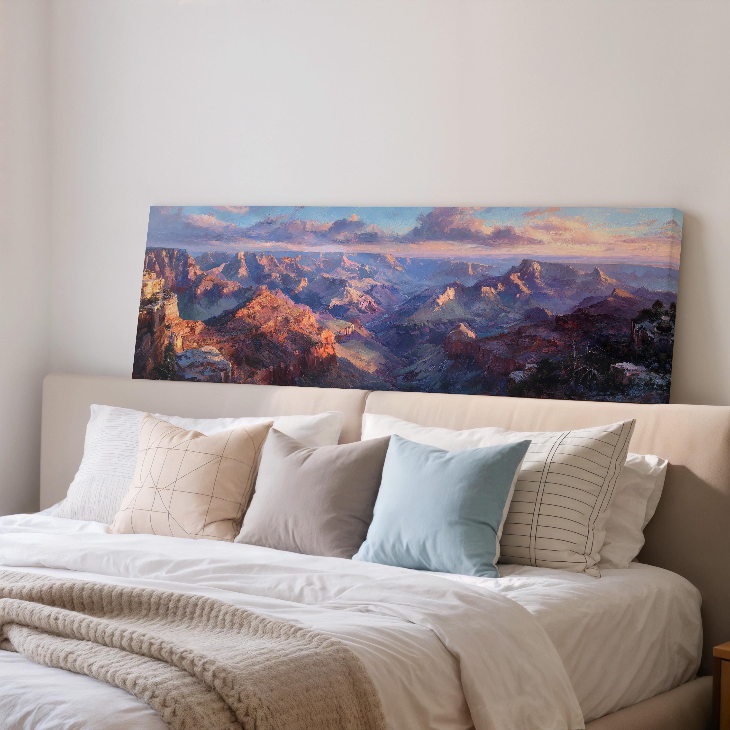 a large, colorful painting of a mountainous landscape hanging on a wall above a bed with white bedding and pillows.