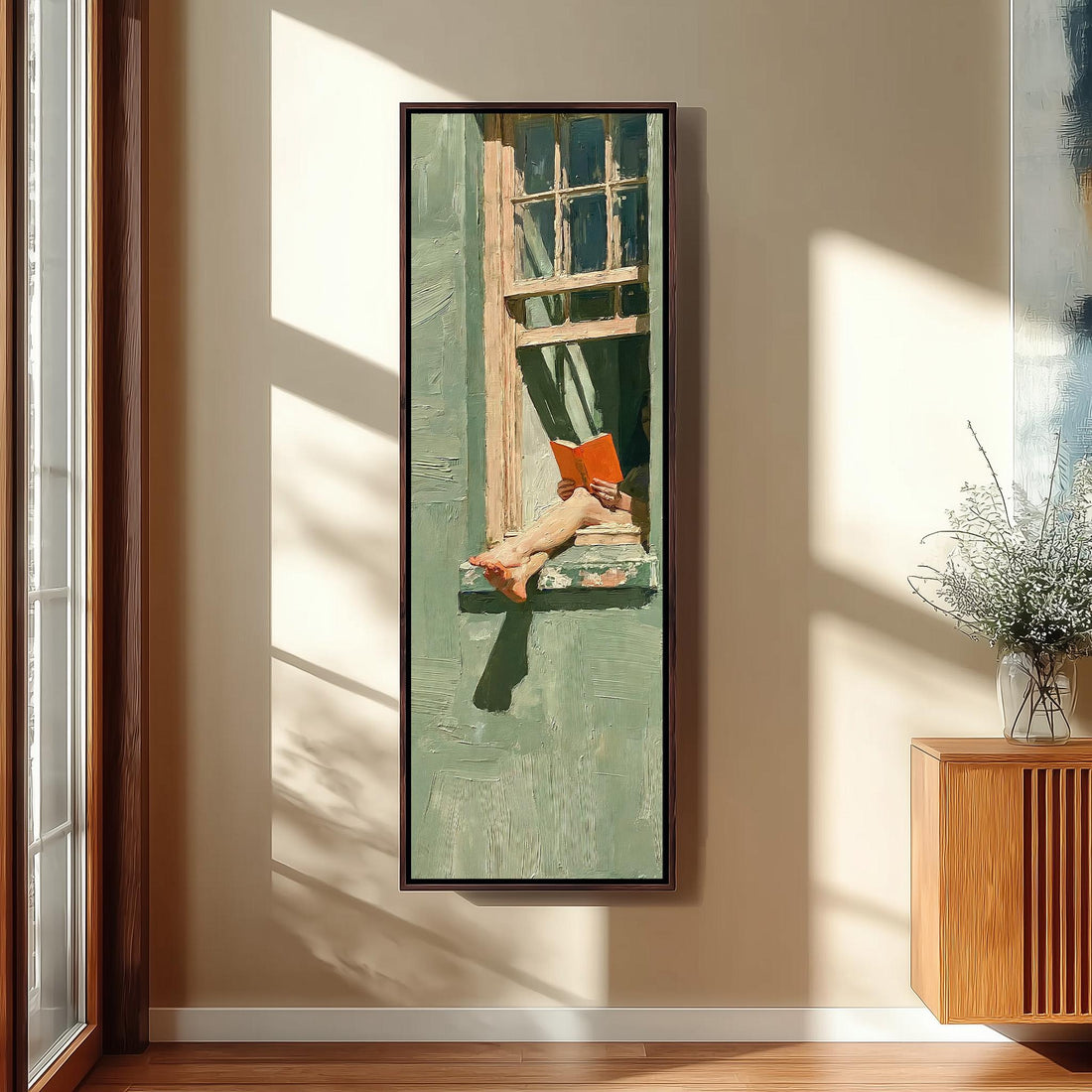 Woman reading in a sage green window long vertical canvas print in a sunlit living space