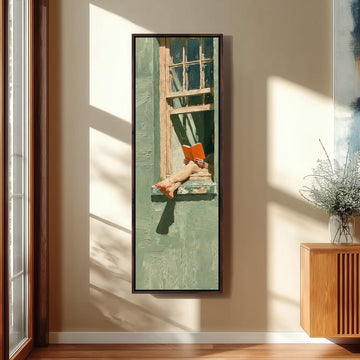 Woman reading in a sage green window long vertical canvas print in a sunlit living space