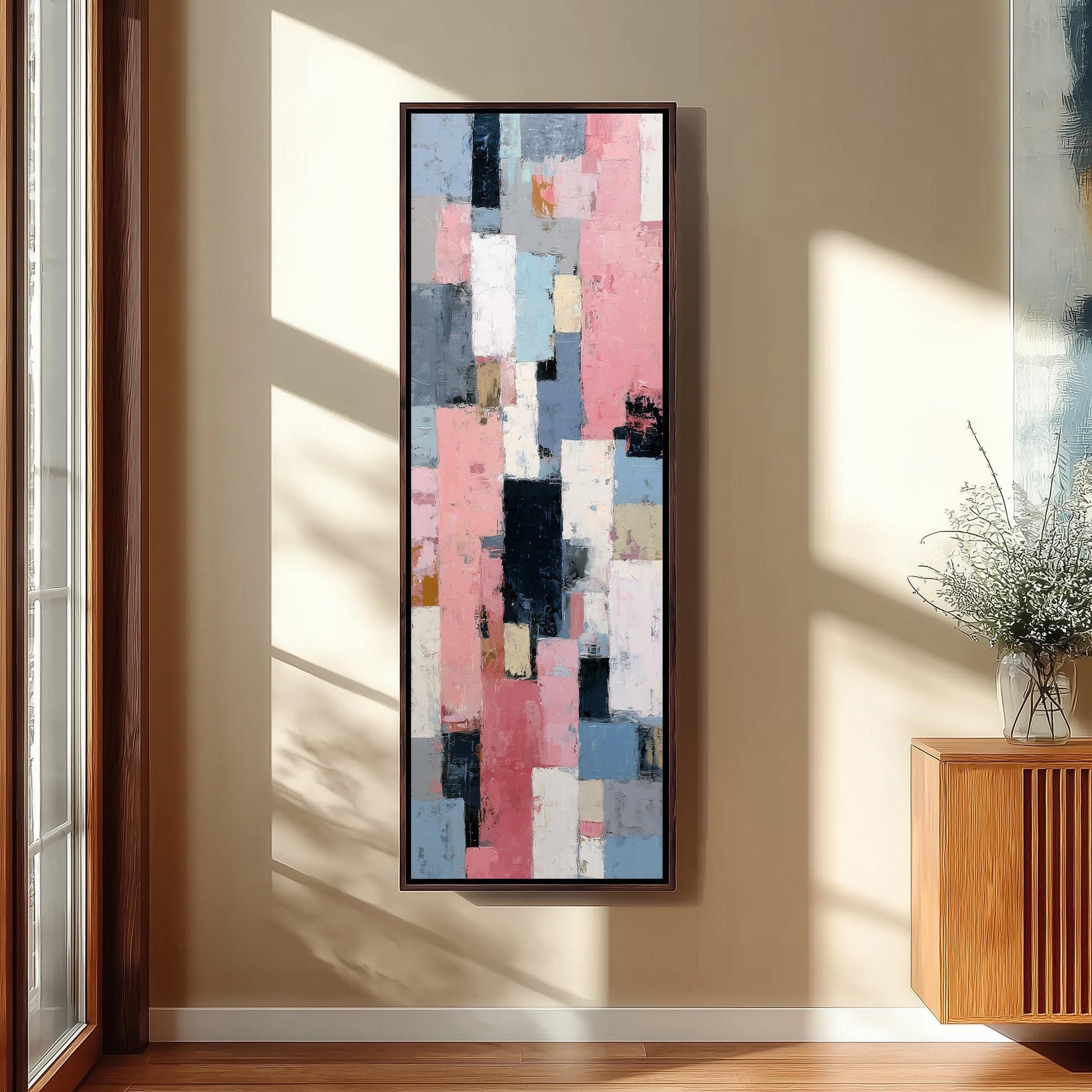 a large abstract painting hanging on a wall in a room with a wooden floor and a window.