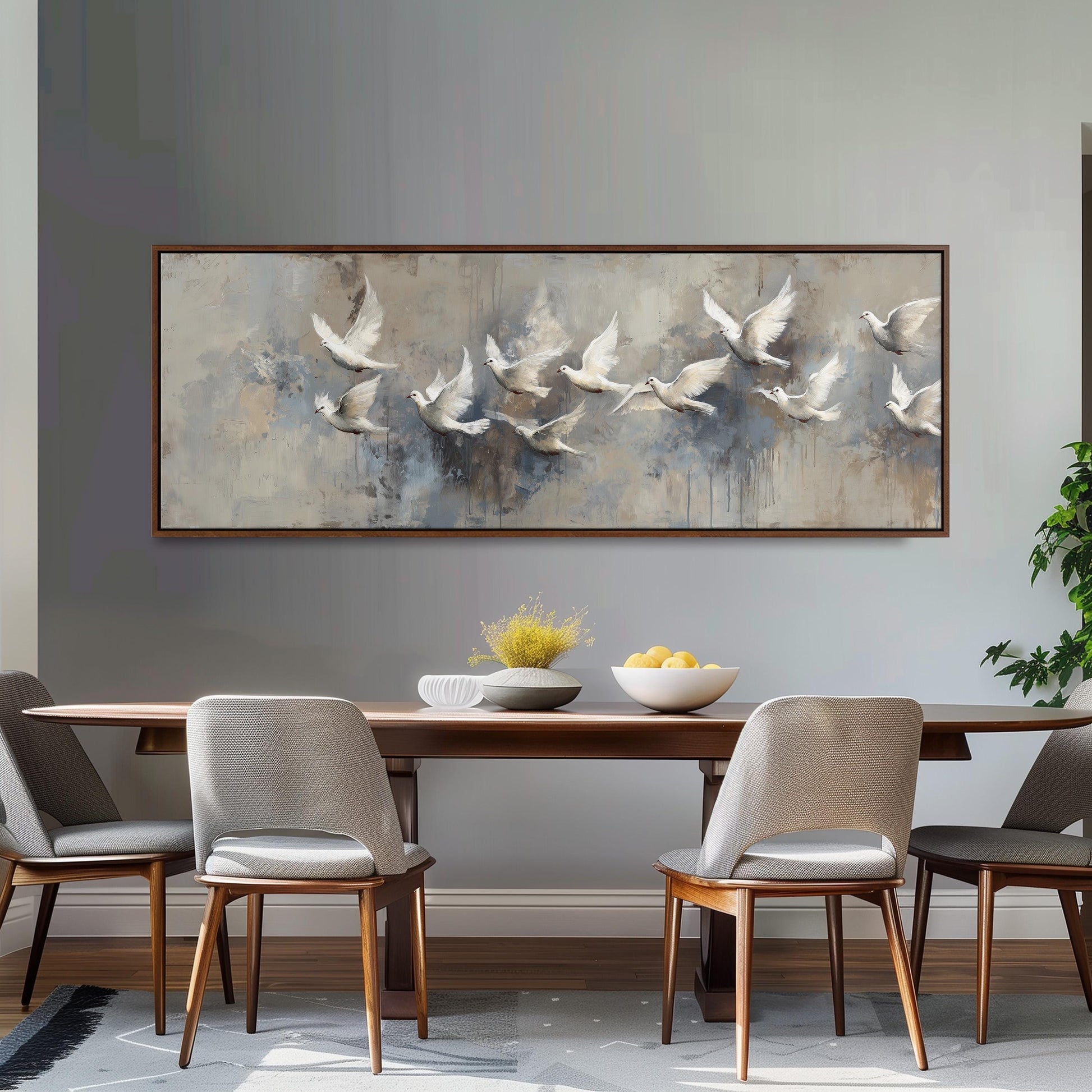 a dining room with a large painting of flying birds hanging on the wall above a wooden dining table with four chairs. The table is set with a bowl of fruit and a vase of flowers, creating a cozy and inviting atmosphere.