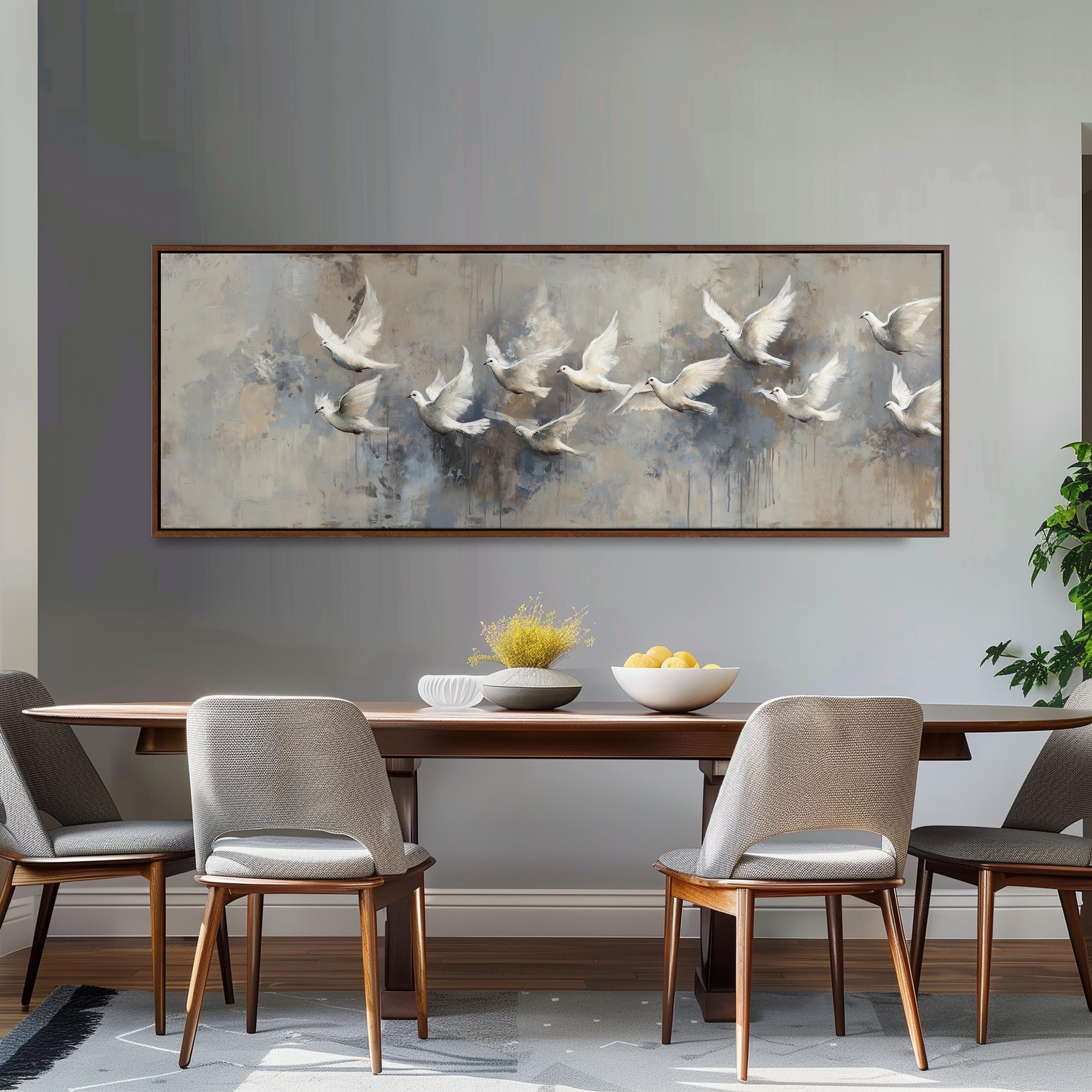 a dining room with a large painting of flying birds hanging on the wall above a wooden dining table with four chairs. The table is set with a bowl of fruit and a vase of flowers, creating a cozy and inviting atmosphere.