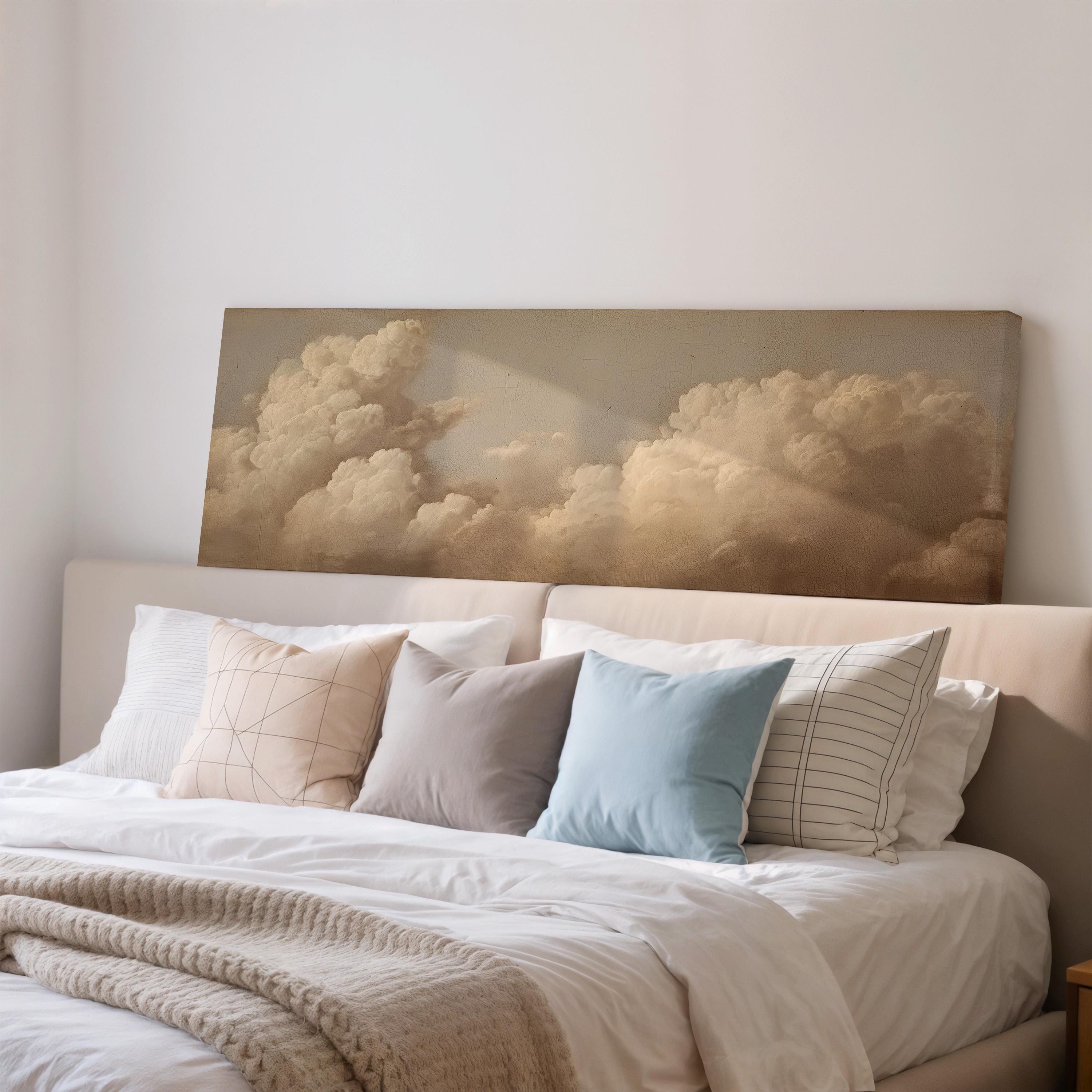 a bedroom with a large bed covered in white sheets and pillows. Above the bed, there is a framed painting of a cloudy sky.