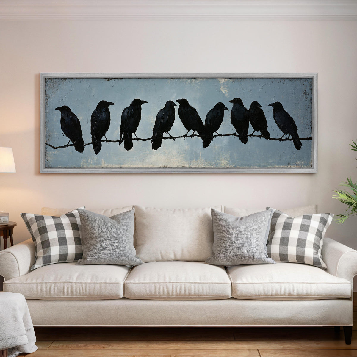 Crows gathered on a branch panoramic canvas print above a white sofa in a bright living room