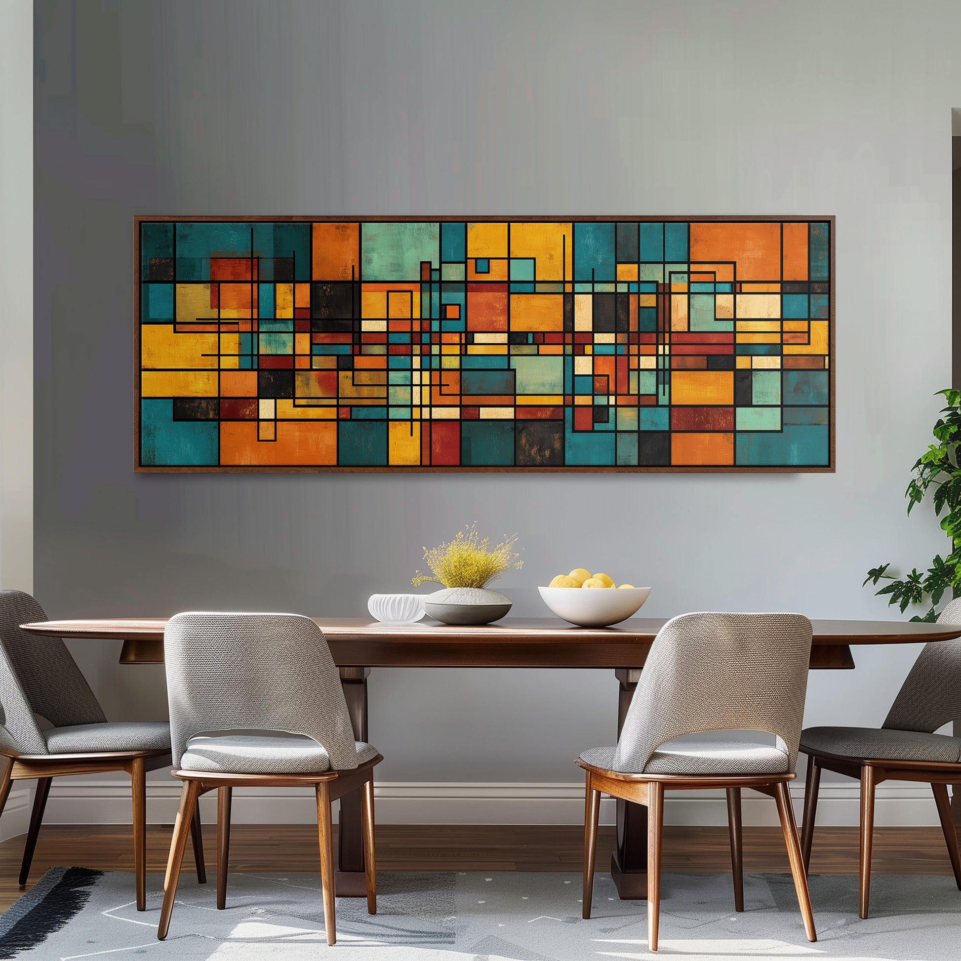 a modern dining room with a large abstract painting hanging on the wall above a wooden dining table with four chairs. The table is set with a bowl of fruit and a vase of flowers, creating a welcoming and stylish atmosphere.