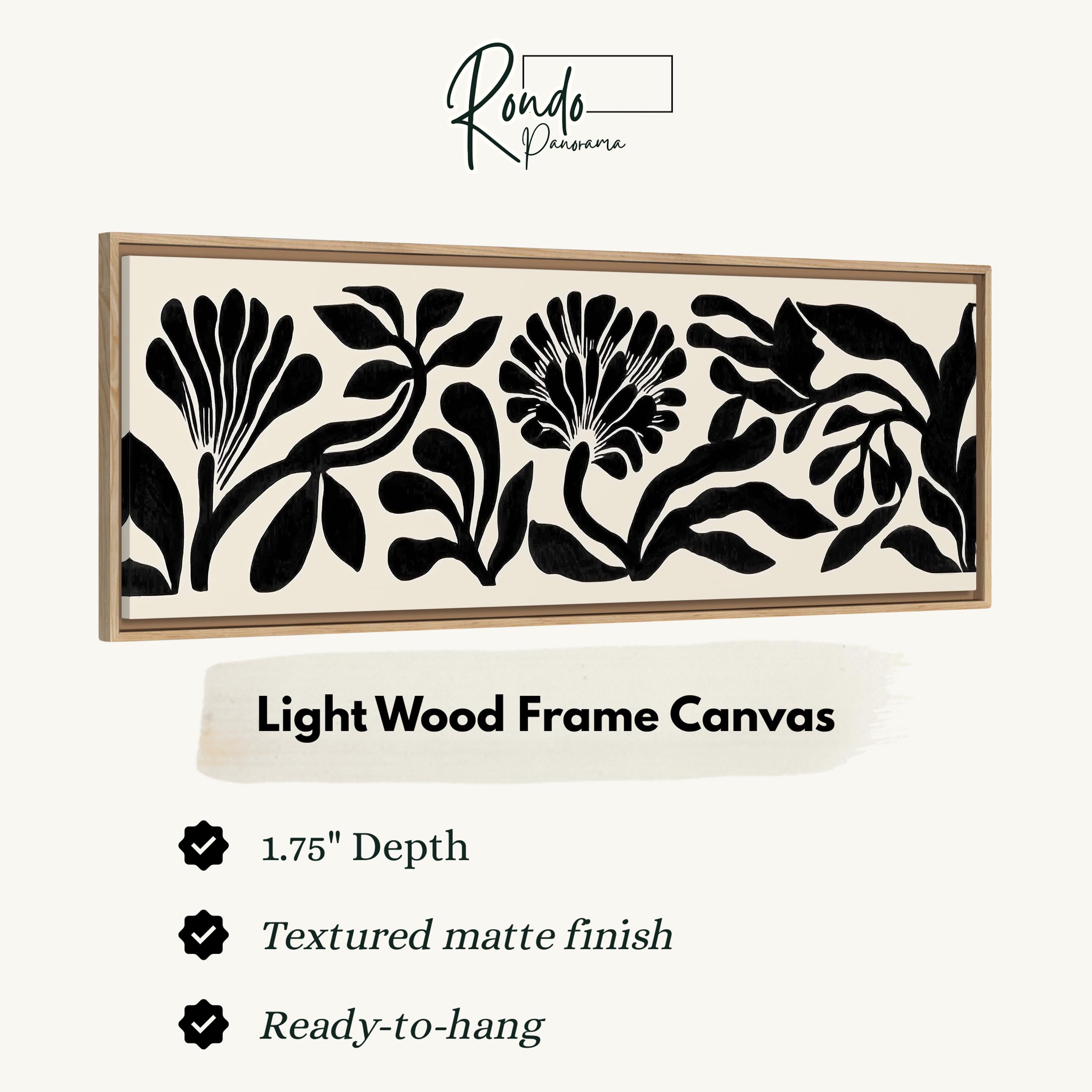 a light wood frame canvas with a floral design in black and white.