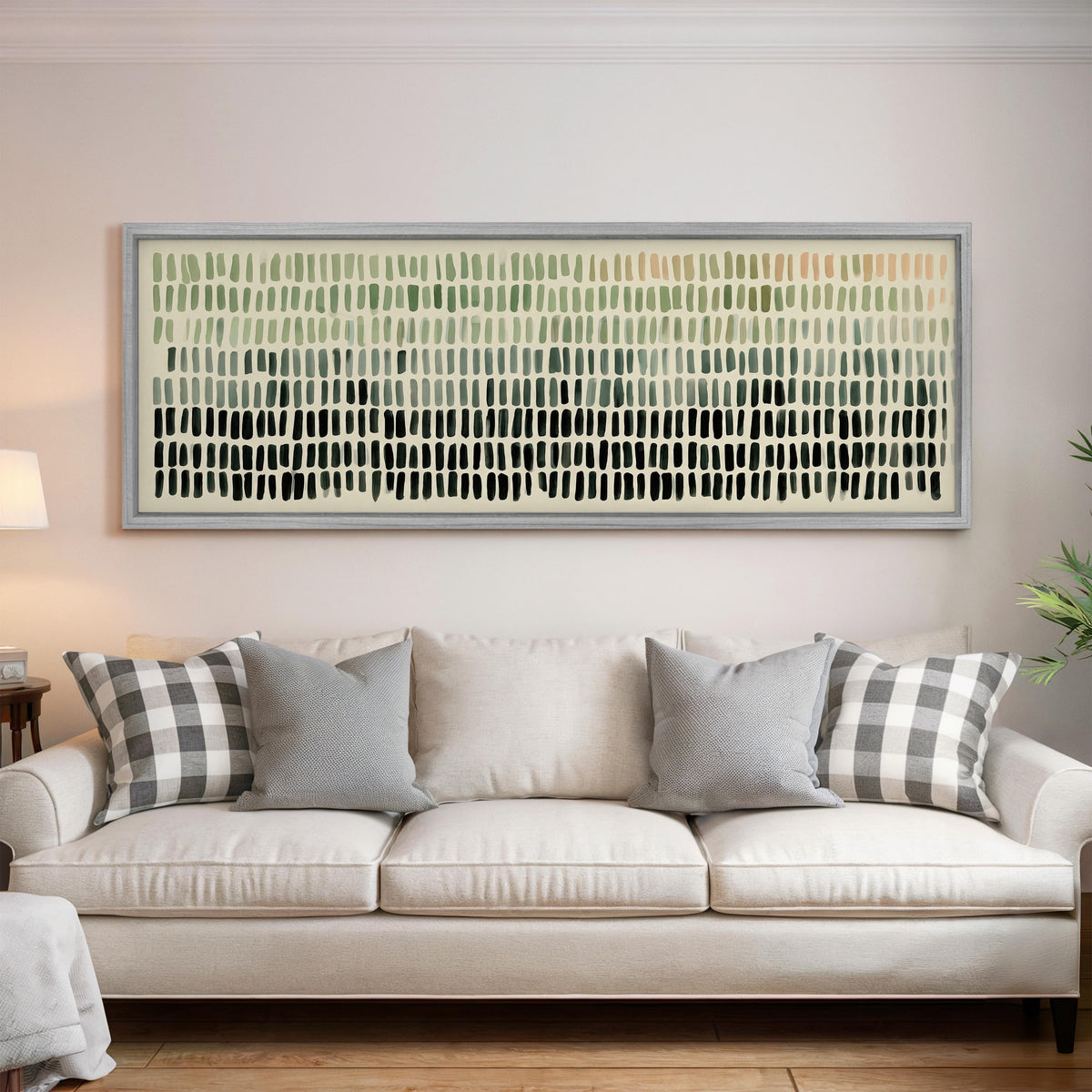 Brushmark dashes fading from sage to charcoal panoramic canvas print above a white sofa in a bright living room