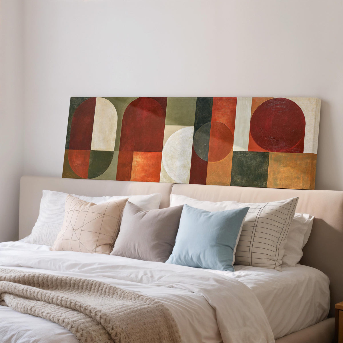 Maroon and olive geometric arches wide panoramic canvas print above a bed in a bedroom