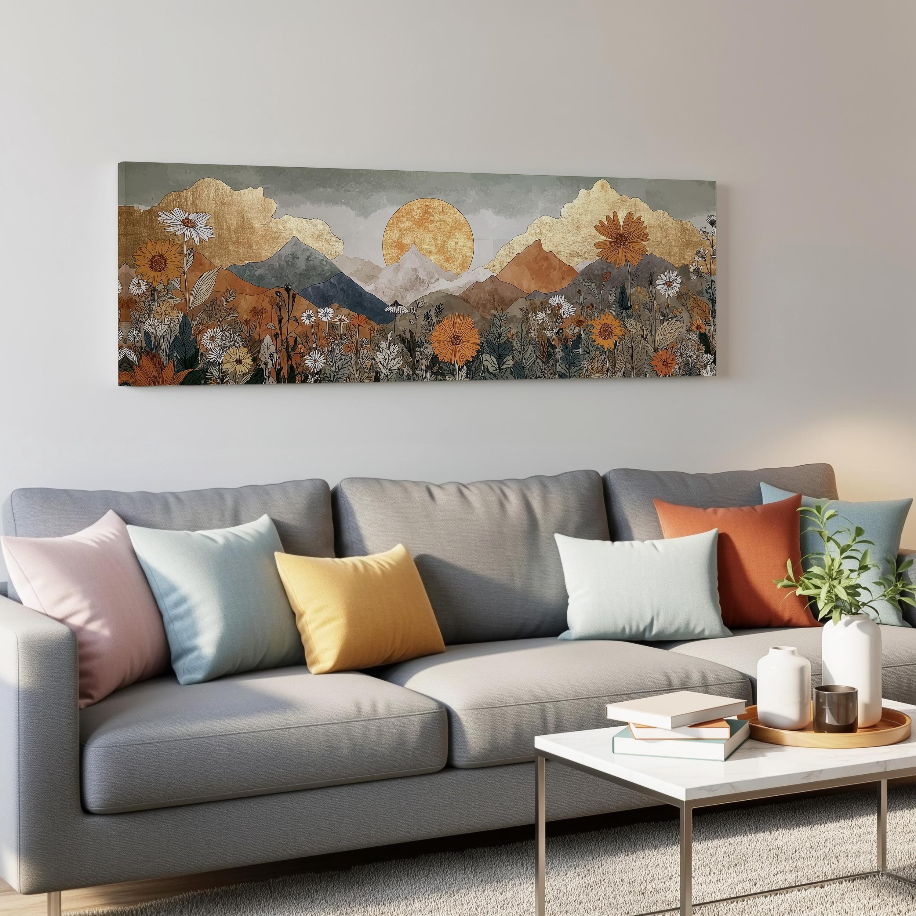 a large, colorful painting of a mountain landscape hanging on a wall above a gray couch with colorful throw pillows.