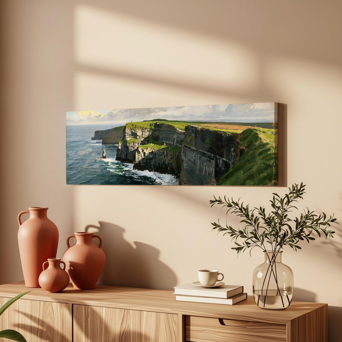 Sunlit sea cliffs with a sea stack long horizontal canvas print above a wooden sideboard