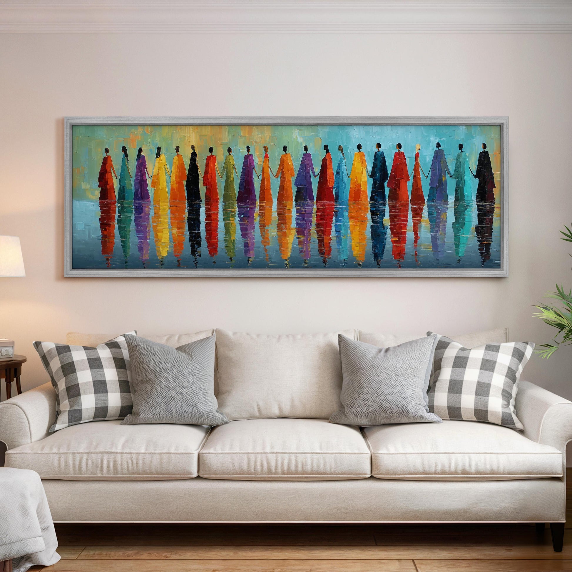 a large, colorful painting of a group of people standing in a line, with their reflections visible in the water below. The painting is displayed on a wall above a white couch, creating a visually striking and vibrant atmosphere in the living room.