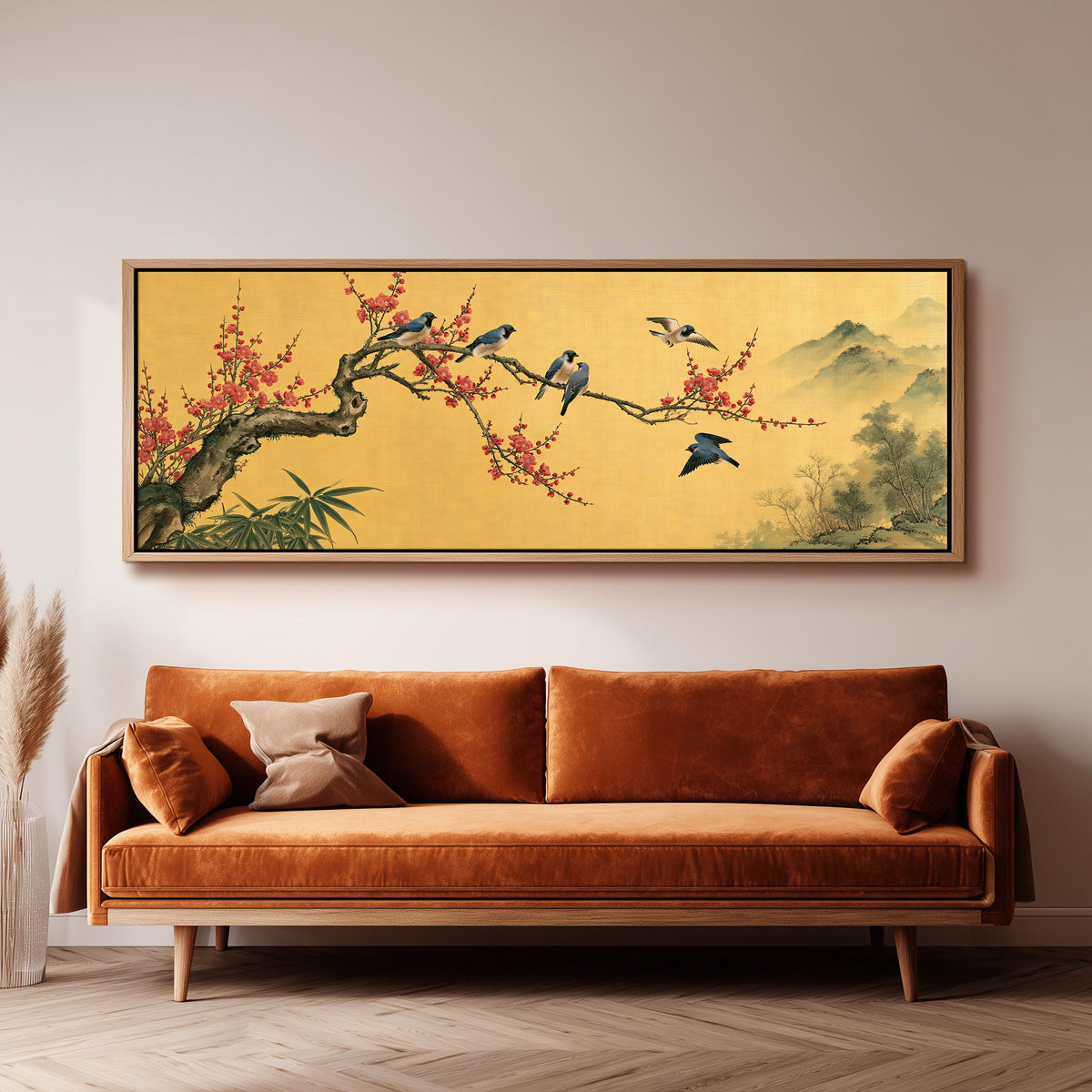 Birds on a plum blossom branch on gold panoramic canvas print above a sofa in a living room