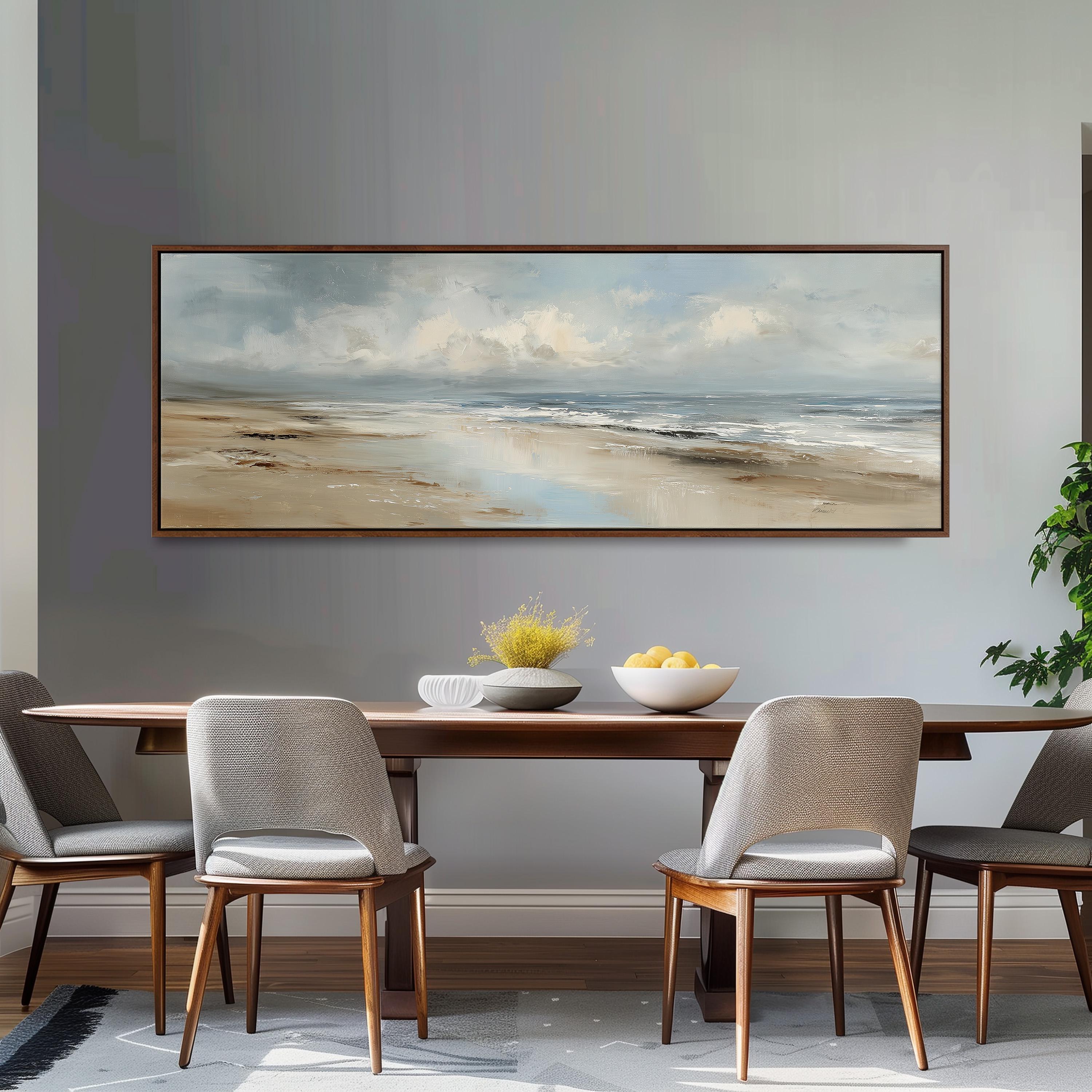 a dining room with a large painting of a beach scene hanging on the wall above a wooden dining table with four chairs. The table is set with a bowl of fruit and a vase of flowers, creating a cozy and inviting atmosphere.