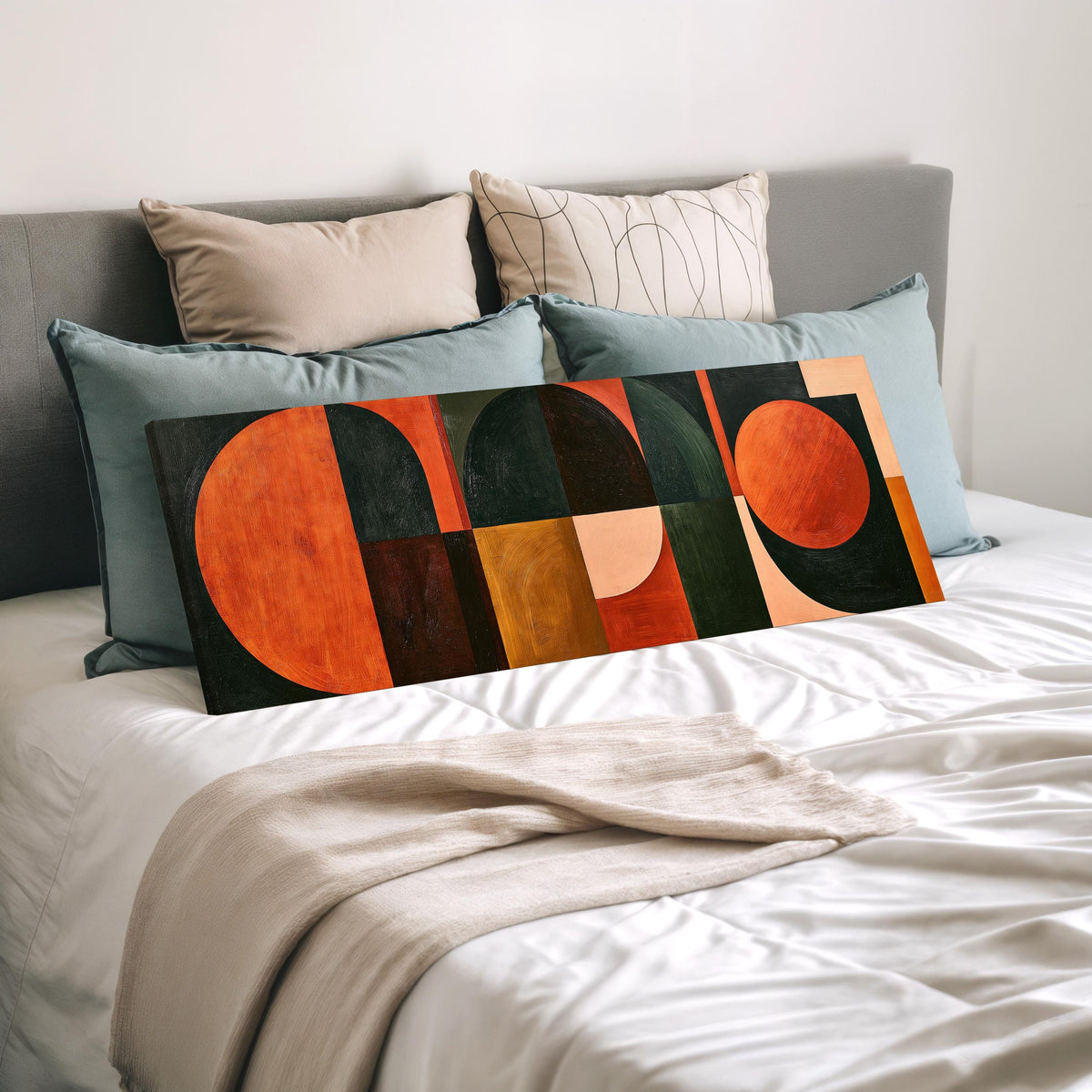 Orange circles and arches on forest green wide panoramic canvas print laid on a bed to show its size