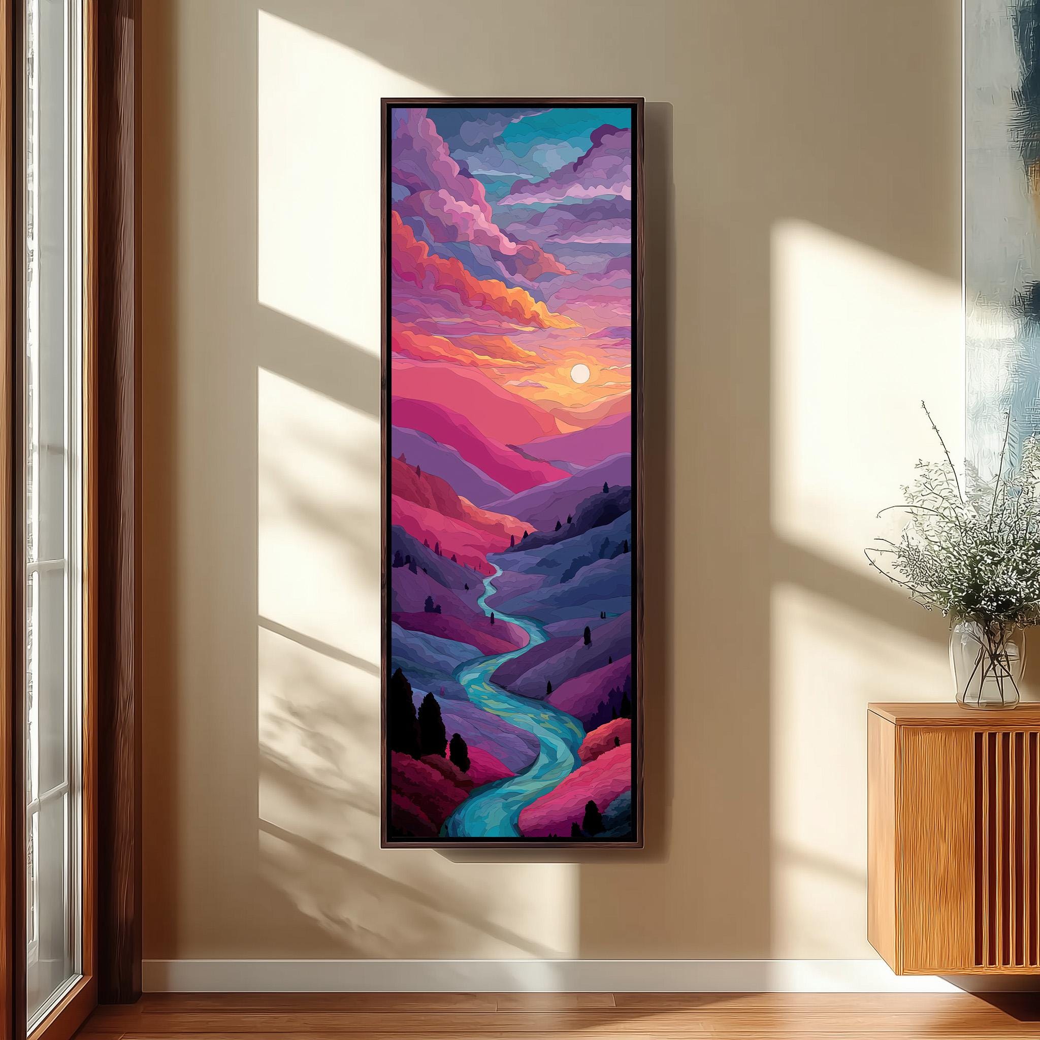 a large, colorful painting of a mountainous landscape with a winding river, set against a vibrant sky with a sun and clouds. The painting is hung on a wall in a room with a wooden cabinet and a vase of flowers nearby.