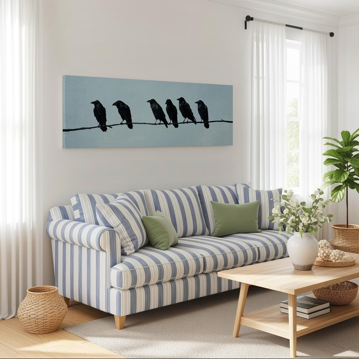 Ravens spaced along a wire long horizontal canvas print above a striped sofa in a coastal living room