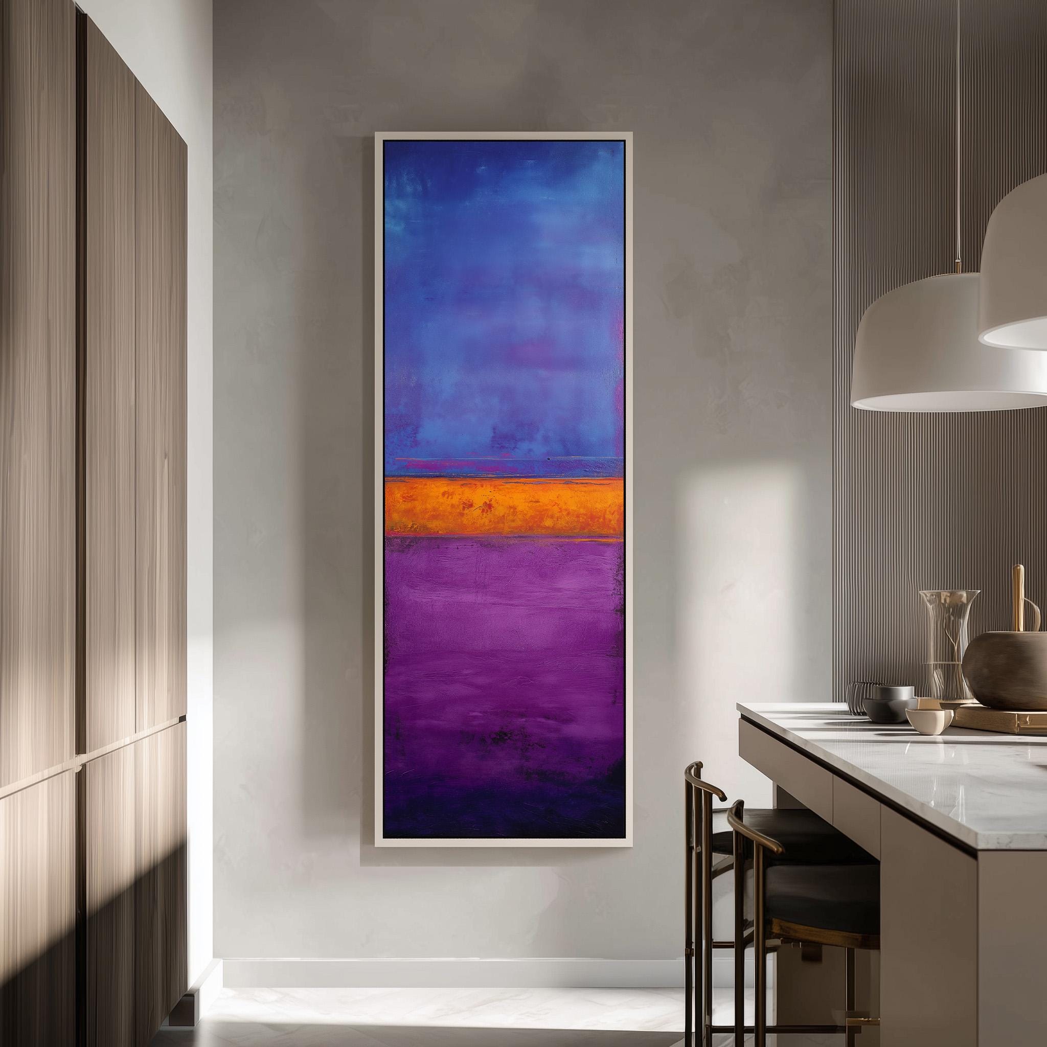 a modern kitchen with a large abstract painting hanging on the wall. The painting has a vibrant mix of blue, purple, and orange colors, creating a striking contrast against the neutral tones of the kitchen.