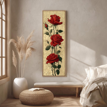 a large painting of three red roses hanging on a wall in a bedroom setting.