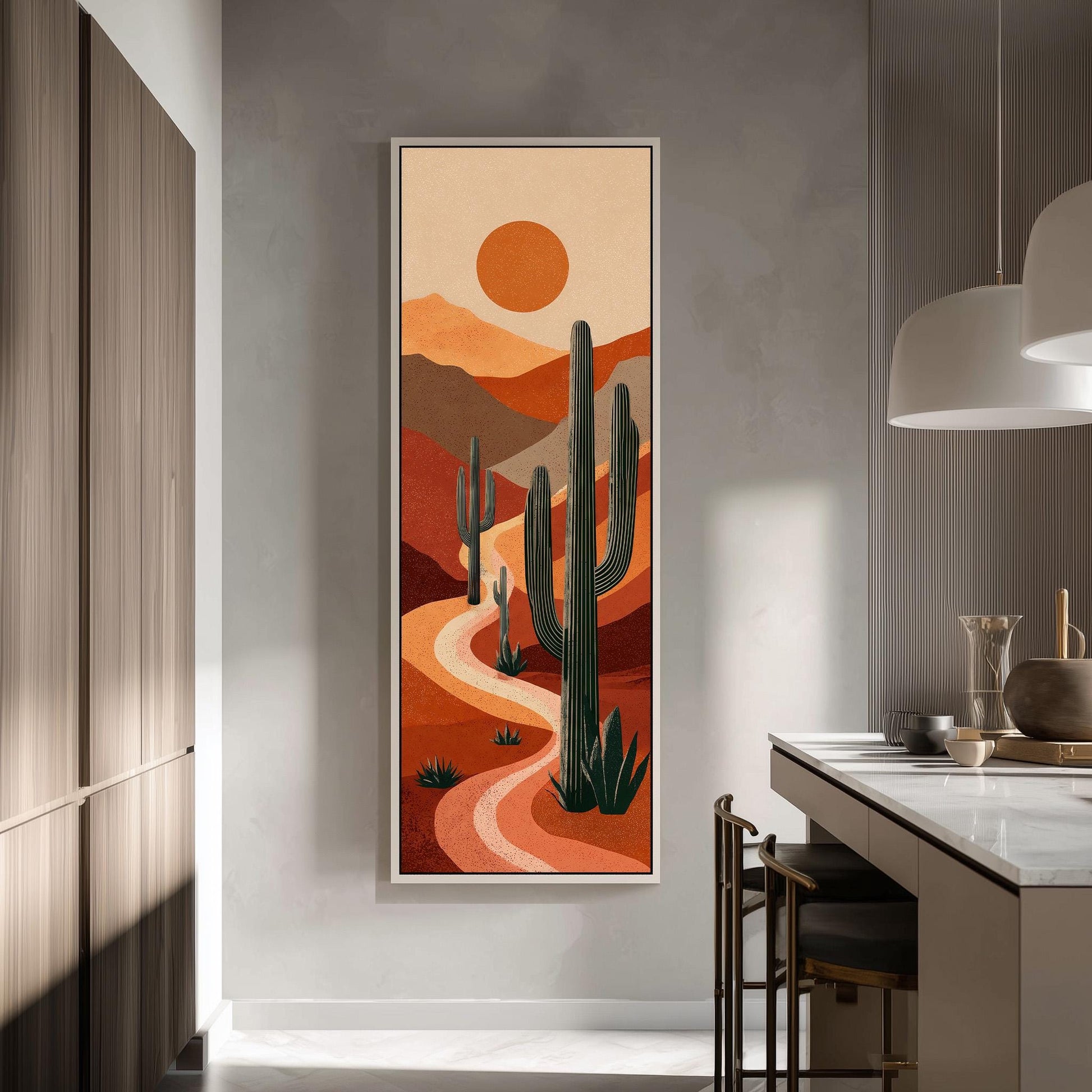 a large framed painting of a desert landscape with cacti and mountains in the background, hanging on a wall in a modern kitchen.