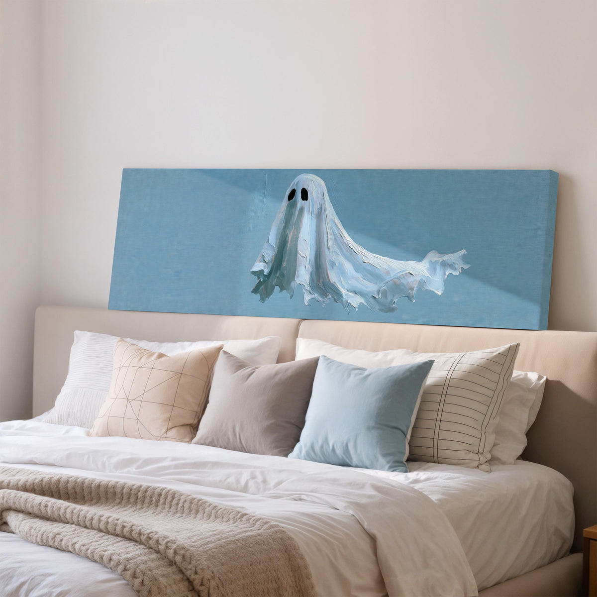Floating ghost on blue wide panoramic canvas print above a bed in a bedroom