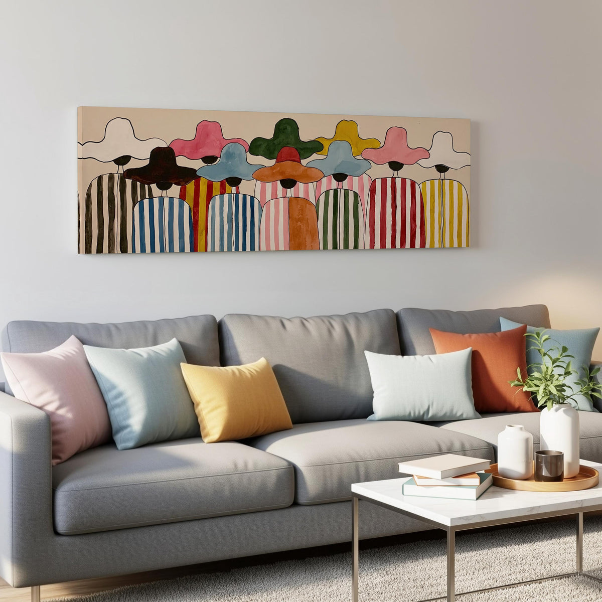 Crowd of figures in colorful sun hats panoramic canvas print above a grey sofa in a living room