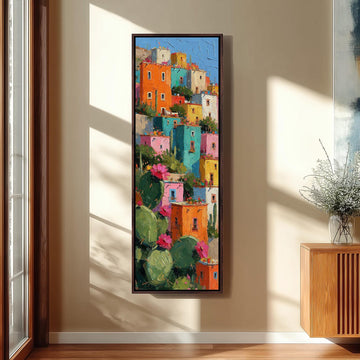 Colorful hillside houses with cacti long vertical canvas print in a sunlit living space