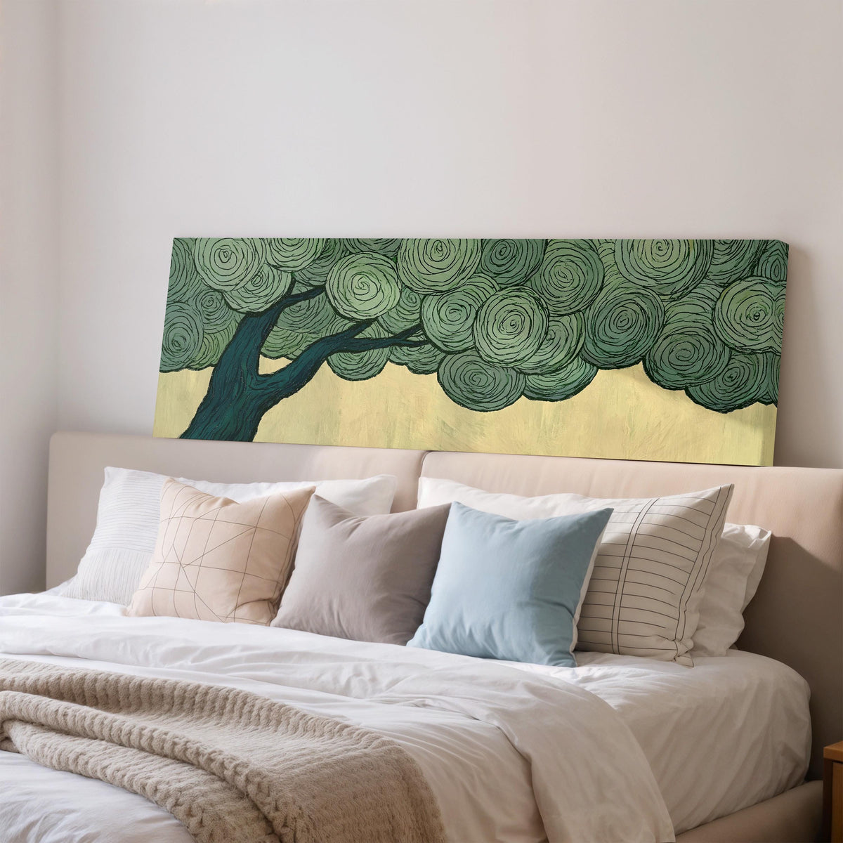 Tree with a swirling green canopy wide panoramic canvas print above a bed in a bedroom